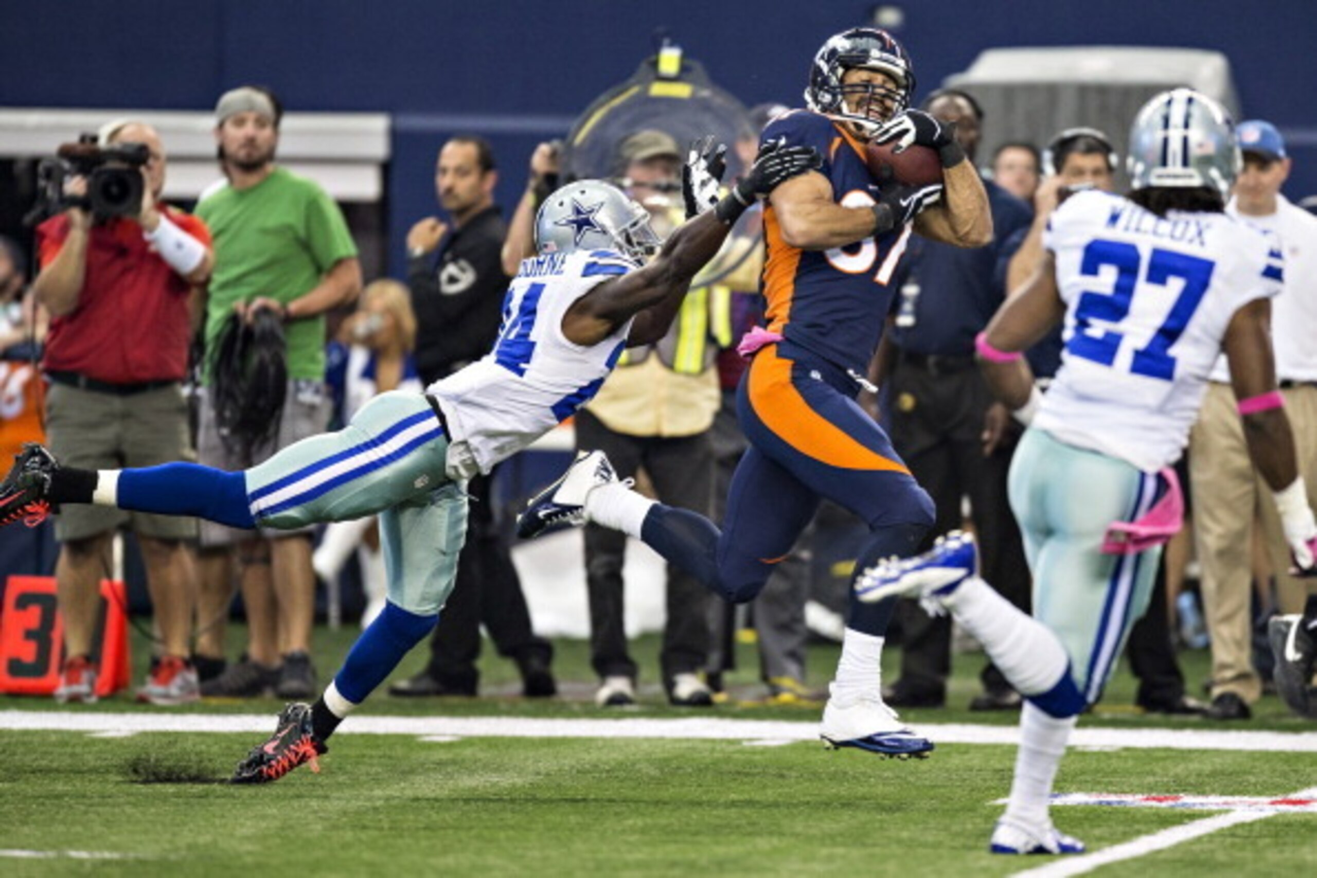 ARLINGTON, TX - OCTOBER 6:  Eric Decker #87 of the Denver Broncos catches a pass over Morris Claiborne #24 of the Dallas Cowboys at AT&T Stadium on October 6, 2013 in Arlington, Texas.  The Broncos defeated the Cowboys 51-48.  (Photo by Wesley Hitt/Getty 