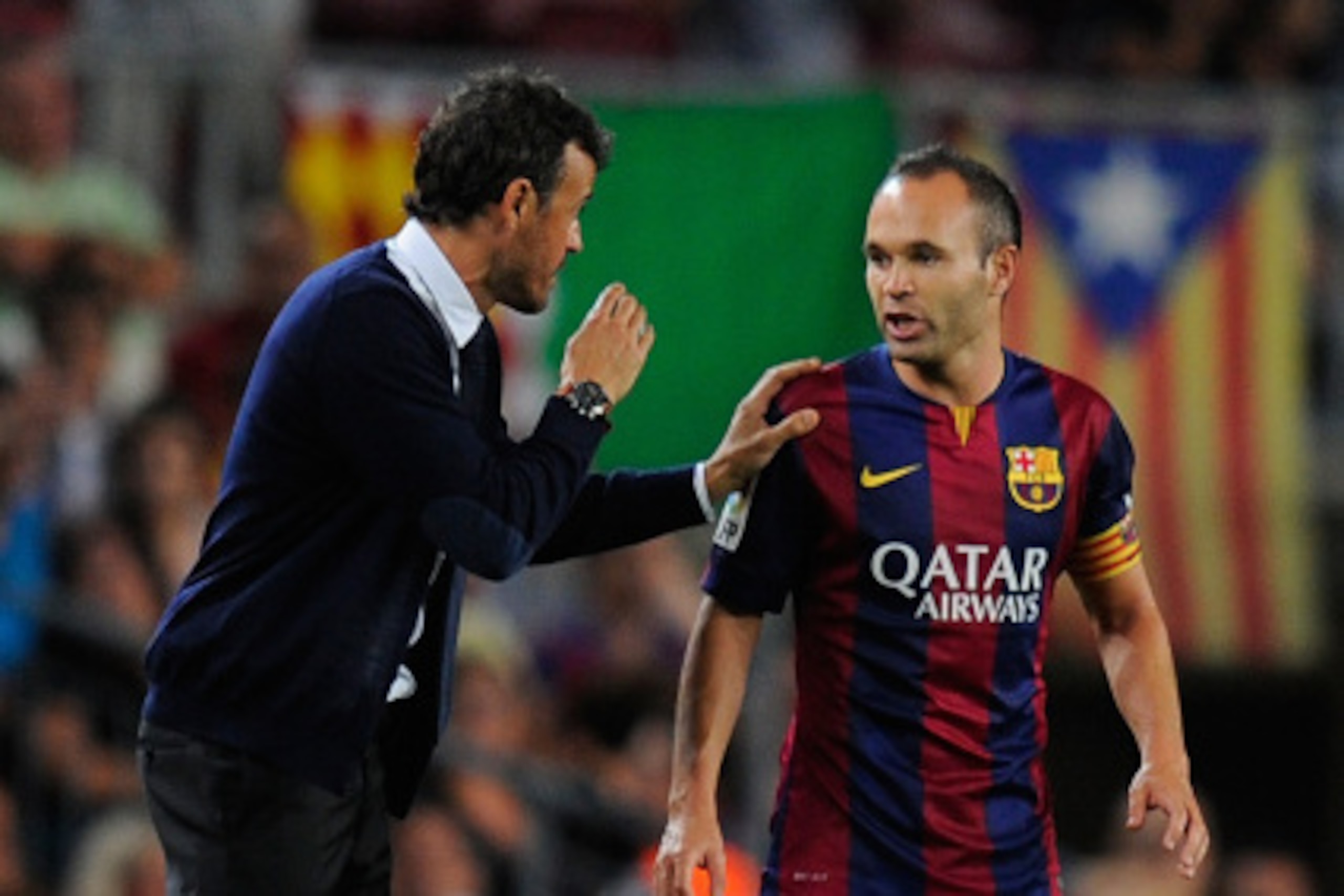 BARCELONA, SPAIN - AUGUST 24: Head coach Luis Enrique (L) of FC Barcelona talks to player Andres Iniesta during the La Liga match between FC Barcelona and Elche FC at Camp Nou stadium on August 24, 2014 in Barcelona, Spain.  (Photo by Denis Doyle/Getty Im