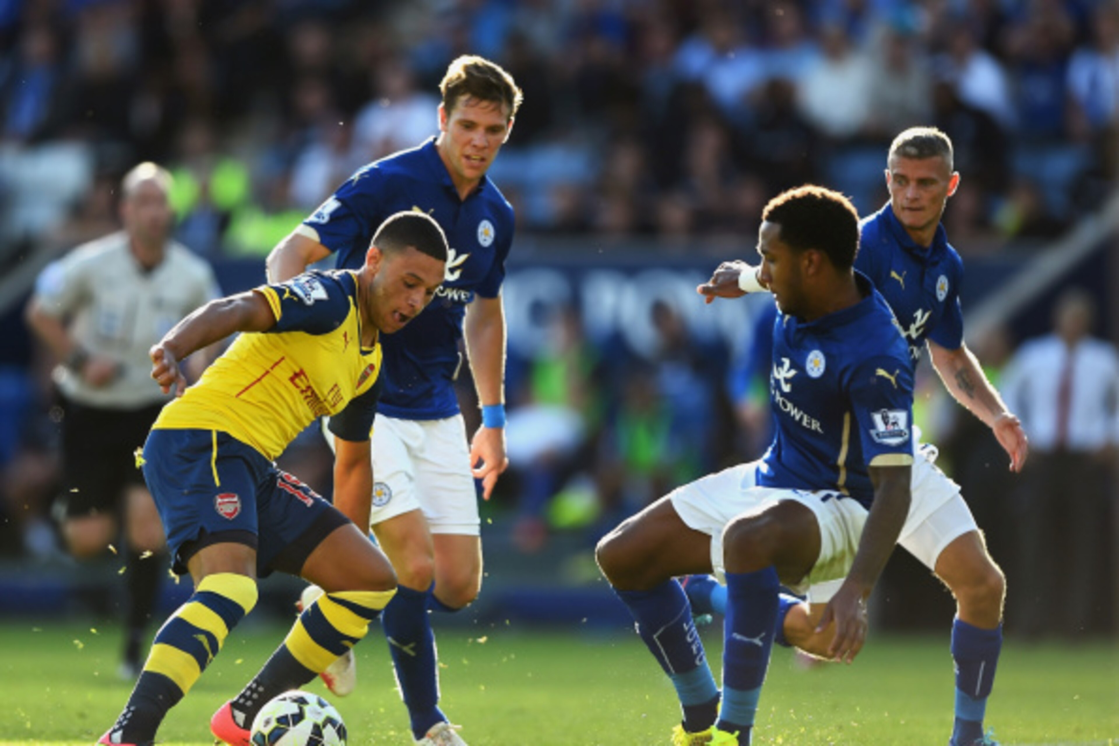 LEICESTER, ENGLAND - AUGUST 31: Alex Oxlade-Chamberlain of Arsenal takes on Dean Hammond, Paul Konchesky and Liam Moore of Leicester City during the Barclays Premier League match between Leicester City and Arsenal at The King Power Stadium on August 31, LEICESTER, ENGLAND - AUGUST 31: Alex Oxlade-Chamberlain of Arsenal takes on Dean Hammond, Paul Konchesky and Liam Moore of Leicester City during the Barclays Premier League match between Leicester City and Arsenal at The King Power Stadium on August 31,
