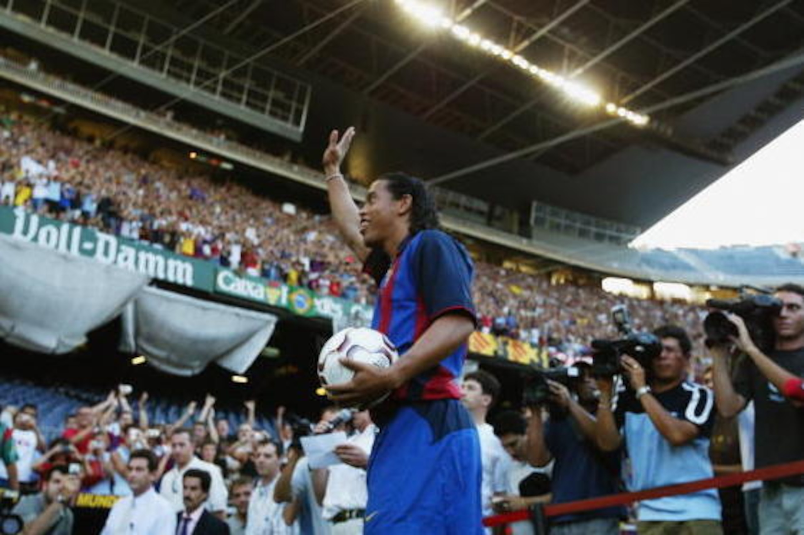 BARCELONA - JULY 21:  Ronaldinho of Brazil waves to the fans during the Barcelona FC Press Conference for the signing of new player Ronaldinho on July 21, 2003 at the Nou Camp in Barcelona, Spain. (Photo By Shaun Botterill/Getty Images)