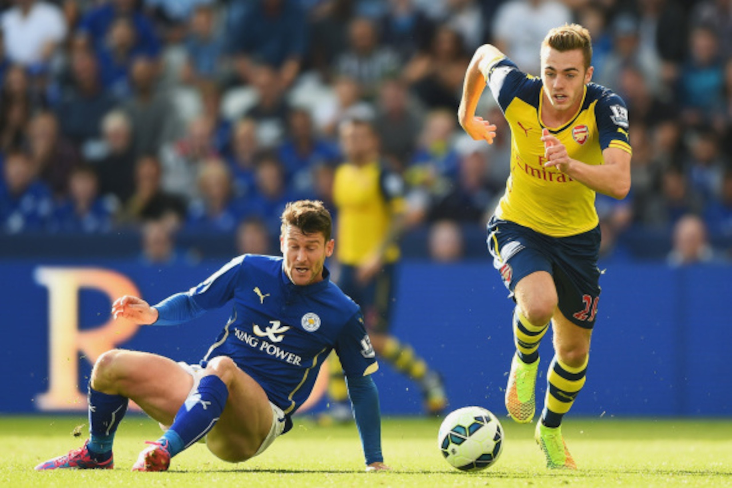 LEICESTER, ENGLAND - AUGUST 31:  Calum Chambers of Arsenal goes past David Nugent of Leicester City during the Barclays Premier League match between Leicester City and Arsenal at The King Power Stadium on August 31, 2014 in Leicester, England.  (Photo by 