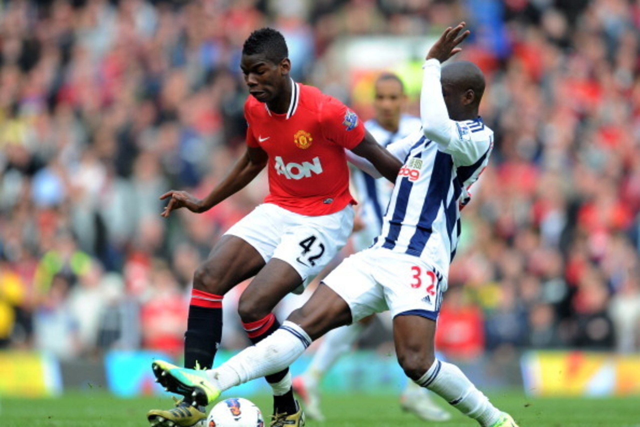MANCHESTER, ENGLAND - MARCH 11: Paul Pogba of Manchester United is challenged by Marc-Antoine Fortune of West Bromwich Albionduring the Barclays Premier League match between Manchester United and West Bromwich Albion at Old Trafford on March 11, 2012 in MANCHESTER, ENGLAND - MARCH 11: Paul Pogba of Manchester United is challenged by Marc-Antoine Fortune of West Bromwich Albionduring the Barclays Premier League match between Manchester United and West Bromwich Albion at Old Trafford on March 11, 2012 in