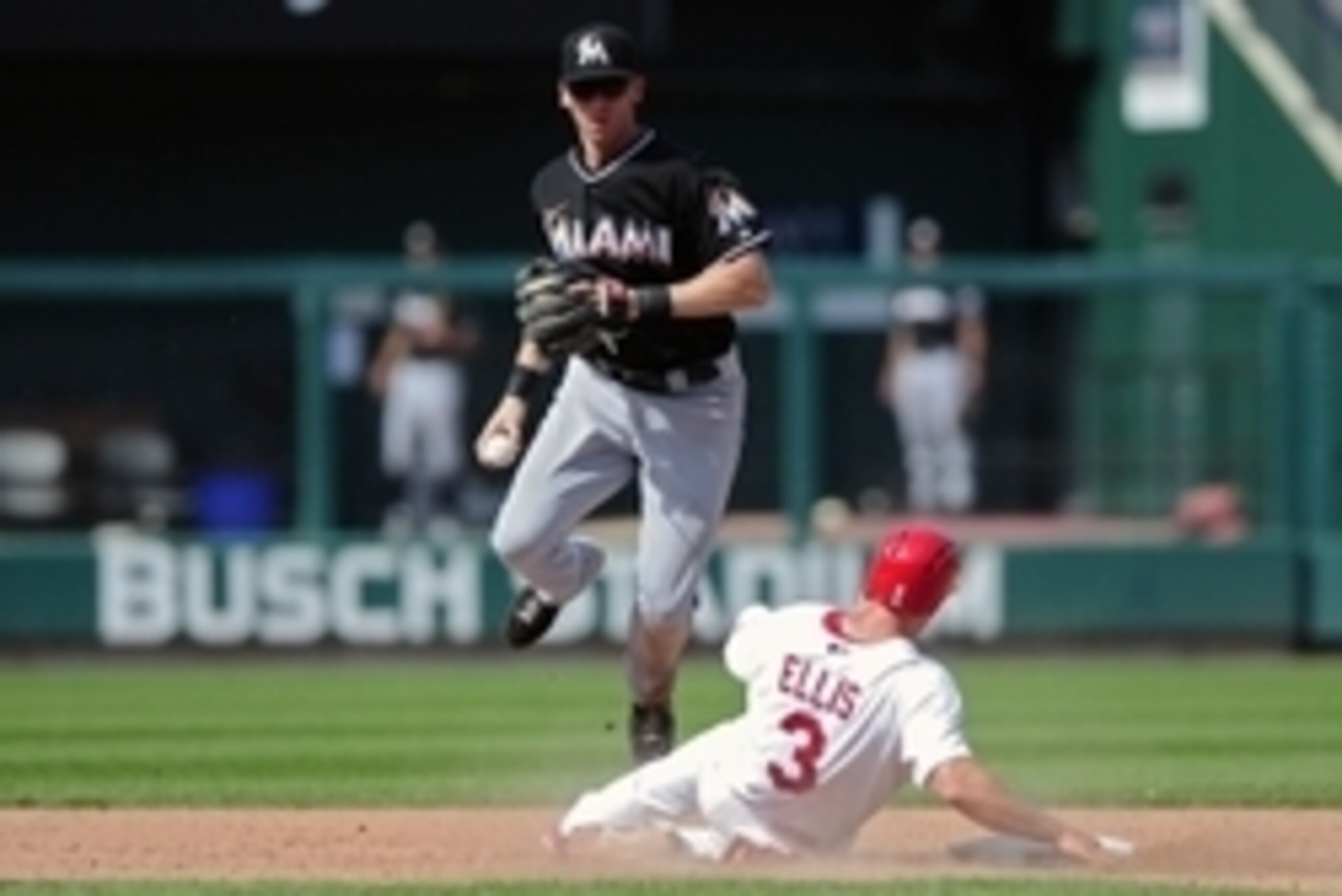 Jul 6, 2014; St. Louis, MO, USA; Miami Marlins second basemans Ed Lucas (59) is unable to complete the double play as St. Louis Cardinals pinch hitter Mark Ellis (3) slides during the ninth inning at Busch Stadium. Marlins defeated the Cardinals 8-4. Mand