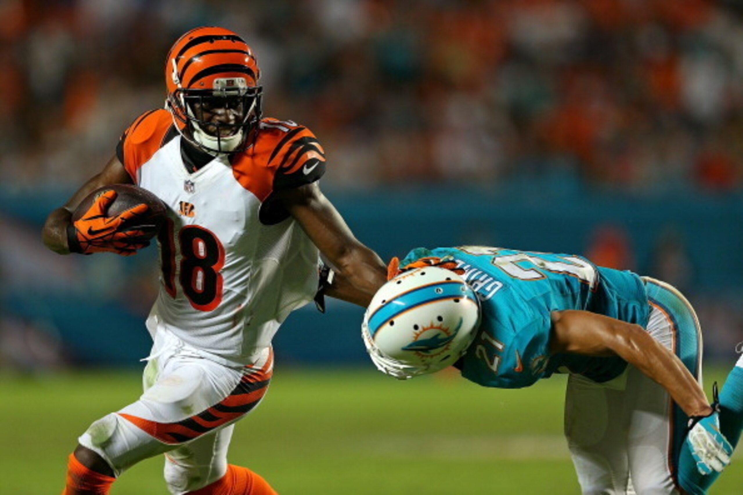 MIAMI GARDENS, FL - OCTOBER 31: A.J. Green #18 of the Cincinnati Bengals pushes off of Brent Grimes #21 of the Miami Dolphins during a game at Sun Life Stadium on October 31, 2013 in Miami Gardens, Florida. (Photo by Mike Ehrmann/Getty Images)