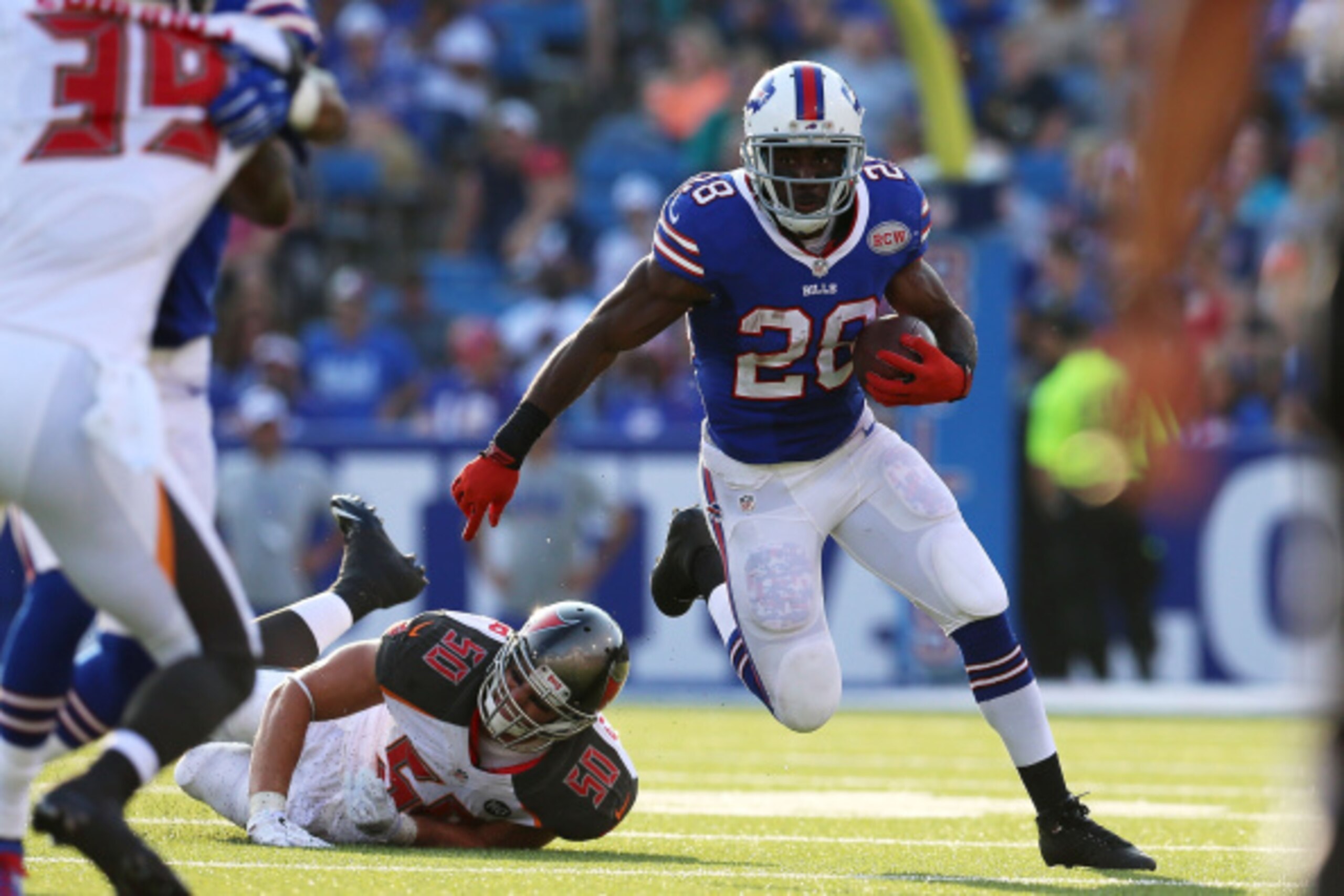 ORCHARD PARK, NY - AUGUST 23:   C.J. Spiller #28 of the Buffalo Bills runs past Dane Fletcher #50 of the Tampa Bay Buccaneers during the second half at Ralph Wilson Stadium on August 23, 2014 in Orchard Park, New York.  (Photo by Vaughn Ridley/Getty Image