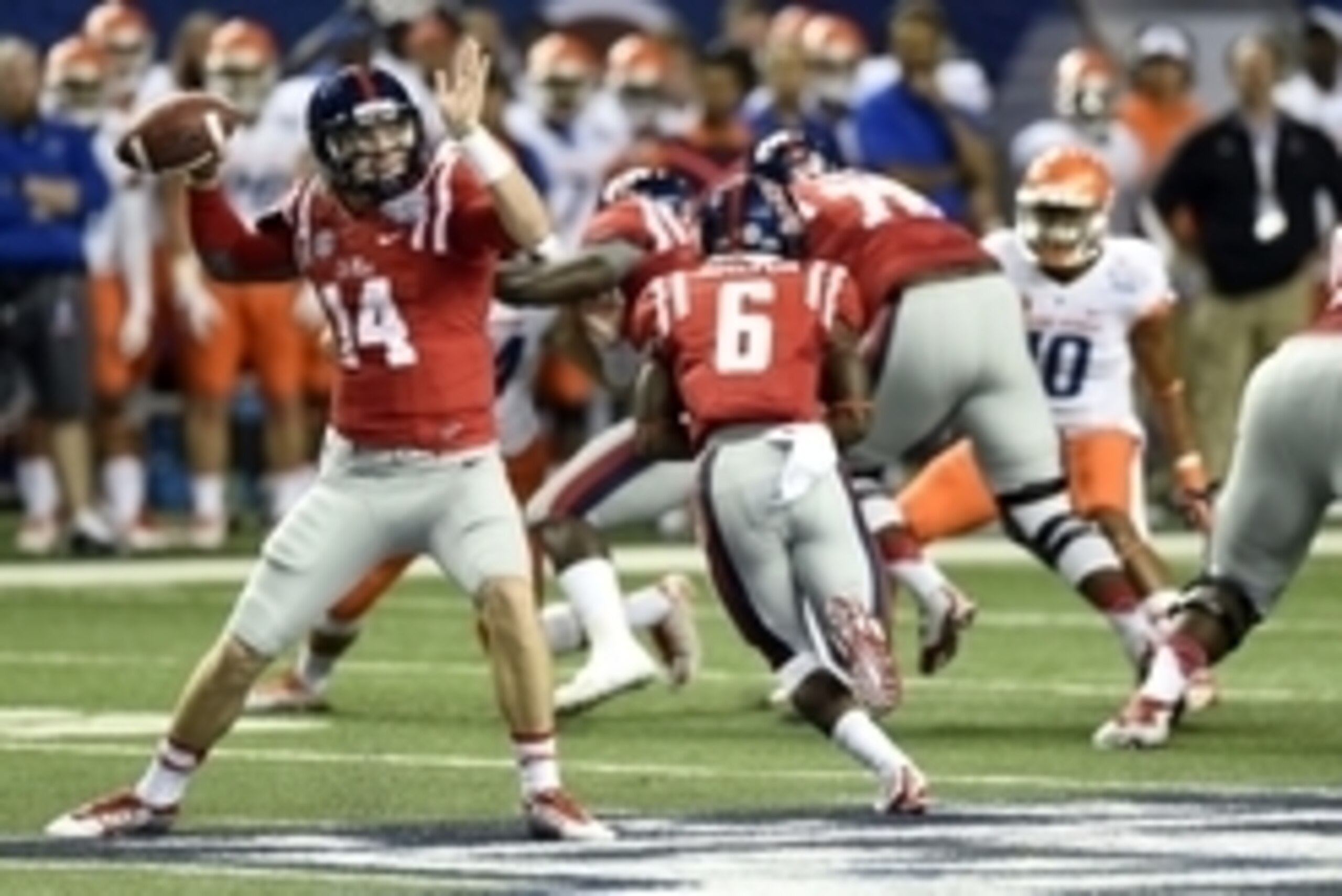 Aug 28, 2014; Atlanta, GA, USA; Mississippi Rebels quarterback Bo Wallace (14) throws against the Boise State Broncos during the first quarter of the 2014 Chick-fil-A kickoff game at the Georgia Dome. Mandatory Credit: John David Mercer-USA TODAY Sports