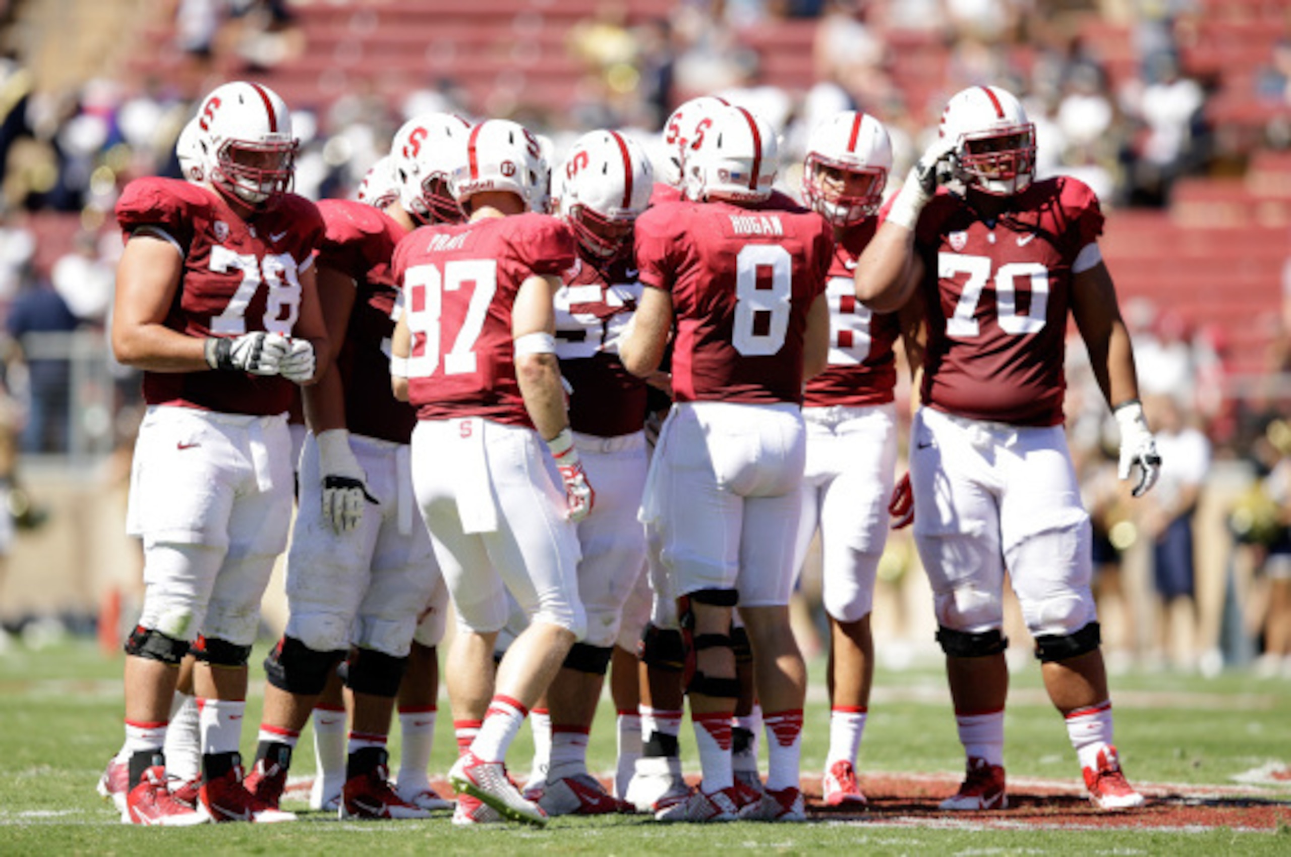 PALO ALTO, CA - AUGUST 30:  Kevin Hogan #8 of the Stanford Cardinal huddles his team together during their game against the UC Davis Aggies at Stanford Stadium on August 30, 2014 in Palo Alto, California.  (Photo by Ezra Shaw/Getty Images)