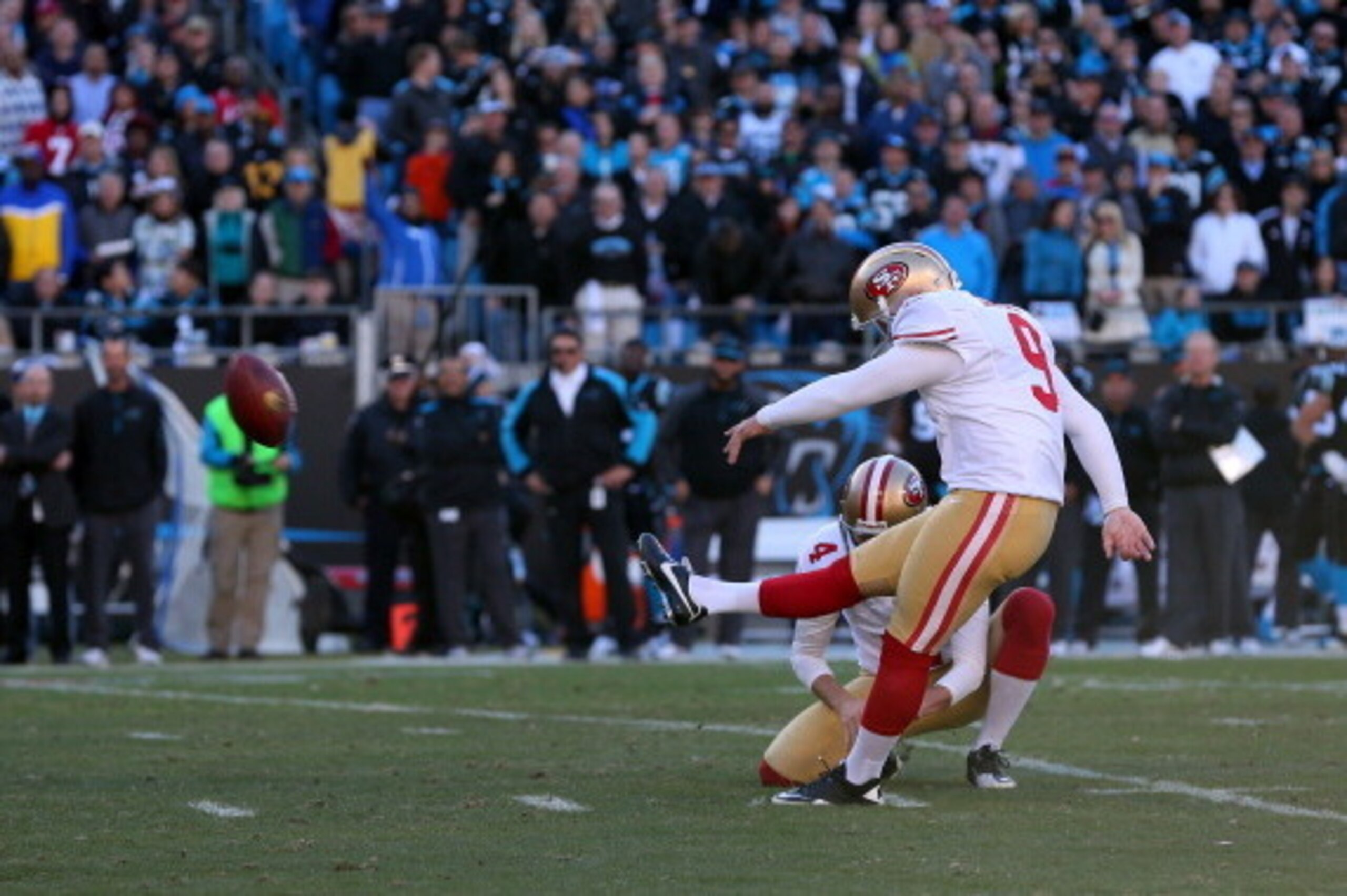 CHARLOTTE, NC - JANUARY 12: Phil Dawson #9 of the San Francisco 49ers kicks a field goal held by Andy Lee #4 in the fourth quarter against the Carolina Panthers during the NFC Divisional Playoff Game at Bank of America Stadium on January 12, 2014 in Charl
