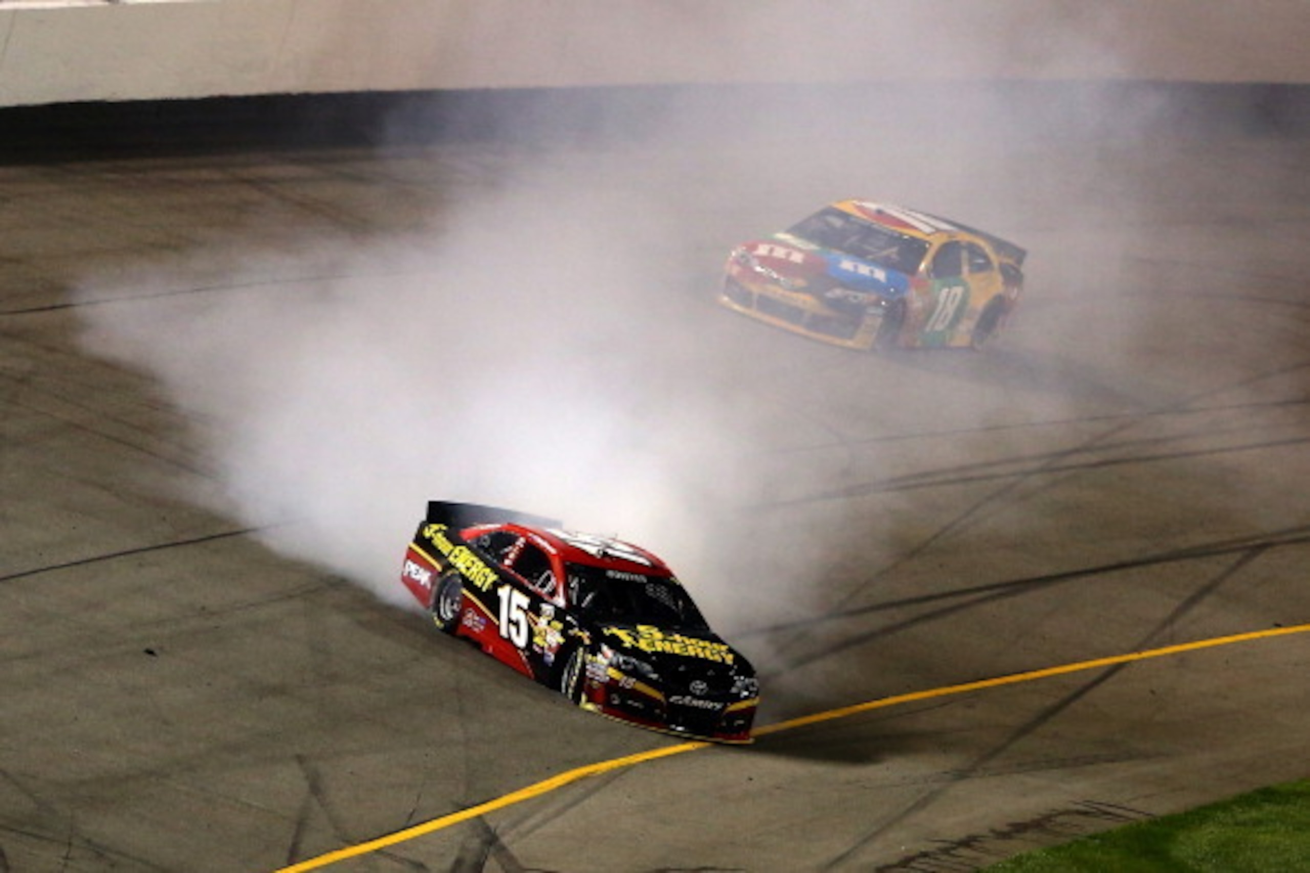 RICHMOND, VA - SEPTEMBER 07:  Clint Bowyer, driver of the #15 5-hour ENERGY Toyota, spins in front of Kyle Busch, driver of the #18 M&M's American Heritage Chocolate Toyota, during the NASCAR Sprint Cup Series 56th Annual Federated Auto Parts 400 at Richm