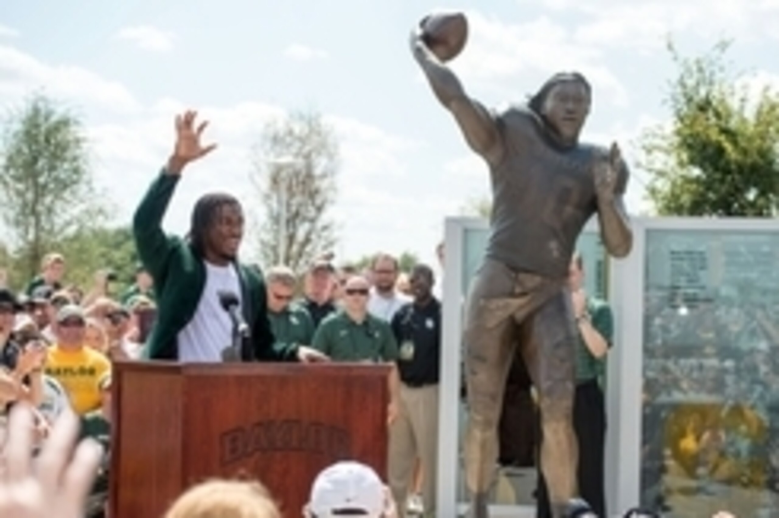 Aug 31, 2014; Waco, TX, USA; Baylor Bears former quarterback Robert Griffin III leads the crowd in a team cheer during his statue unveiling before the game between the Bears and the Southern Methodist Mustangs during the game at McLane Stadium. Mandatory 