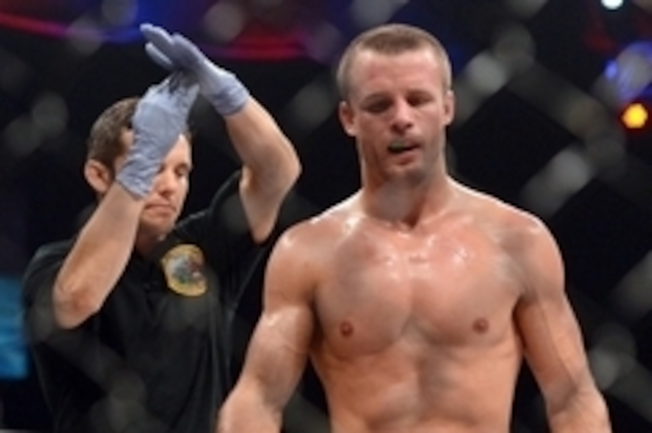 Nov 2, 2013; Long Beach, CA, USA;   Pat Curran (blue gloves) is assisted by referee Jason Herzog during the Bellator featherweight world championship fight against Daniel Straus (not pictured) at the Long Beach Arena. Daniel Strauss won by decision. Manda