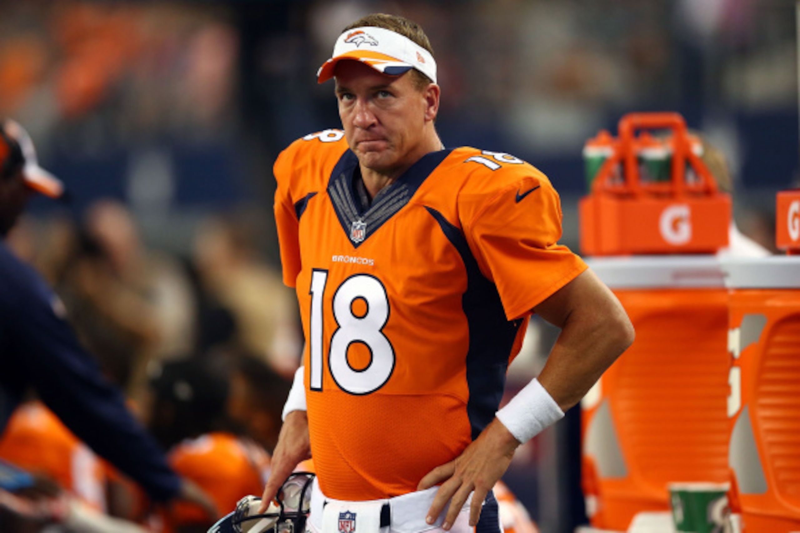 ARLINGTON, TX - AUGUST 28: Peyton Manning #18 of the Denver Broncos watches from the sidelines against the Dallas Cowboys in the first half of their preseason game at AT&T Stadium on August 28, 2014 in Arlington, Texas. (Photo by Ronald Martinez/Getty ARLINGTON, TX - AUGUST 28: Peyton Manning #18 of the Denver Broncos watches from the sidelines against the Dallas Cowboys in the first half of their preseason game at AT&T Stadium on August 28, 2014 in Arlington, Texas. (Photo by Ronald Martinez/Getty