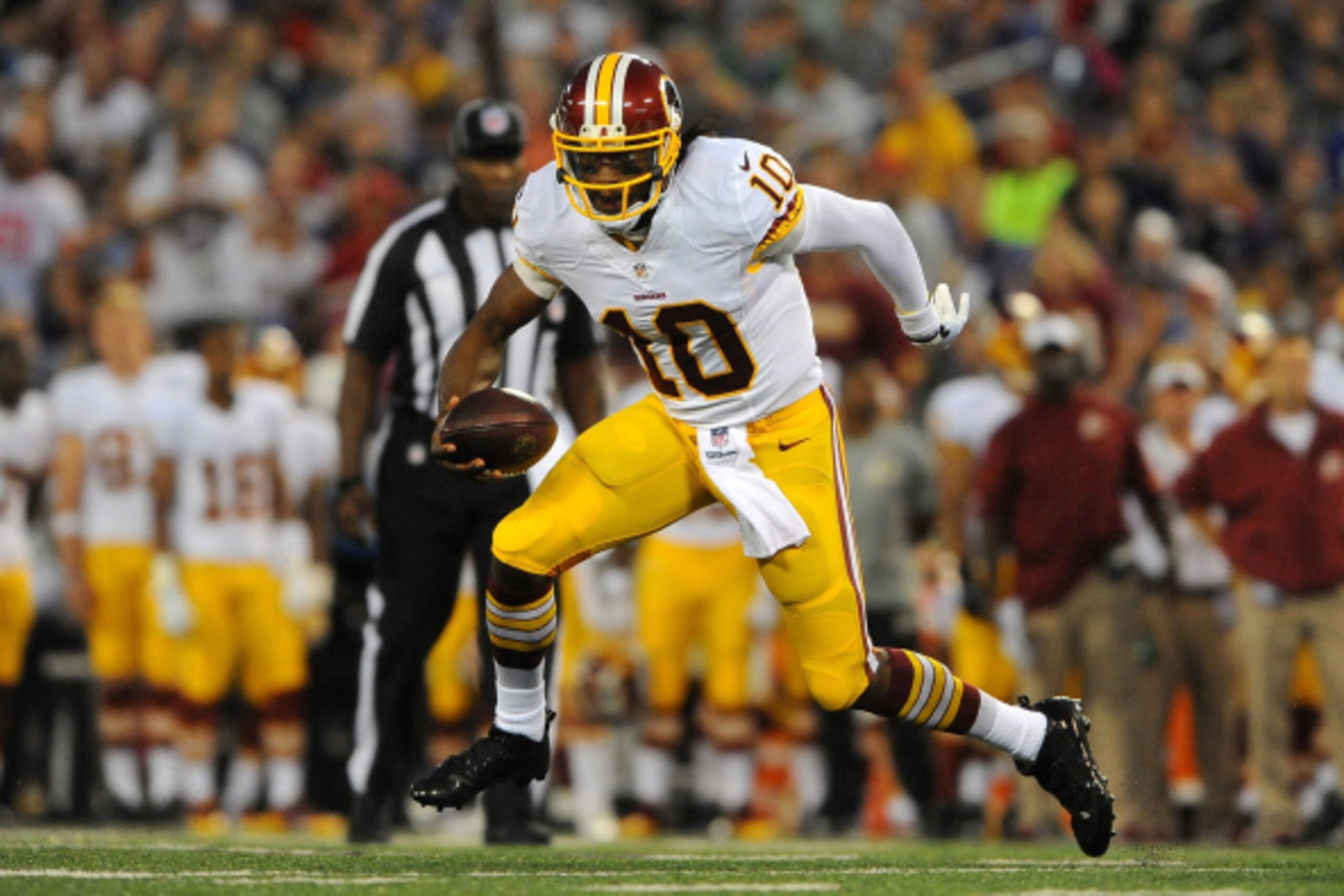 BALTIMORE, MD - AUGUST 23:  Quarterback Robert Griffin III #10 of the Washington Redskins scrambles during a preseason game against the Baltimore Ravens at M&T Bank Stadium on August 23, 2014 in Baltimore, Maryland.  (Photo by Larry French/Getty Images)
