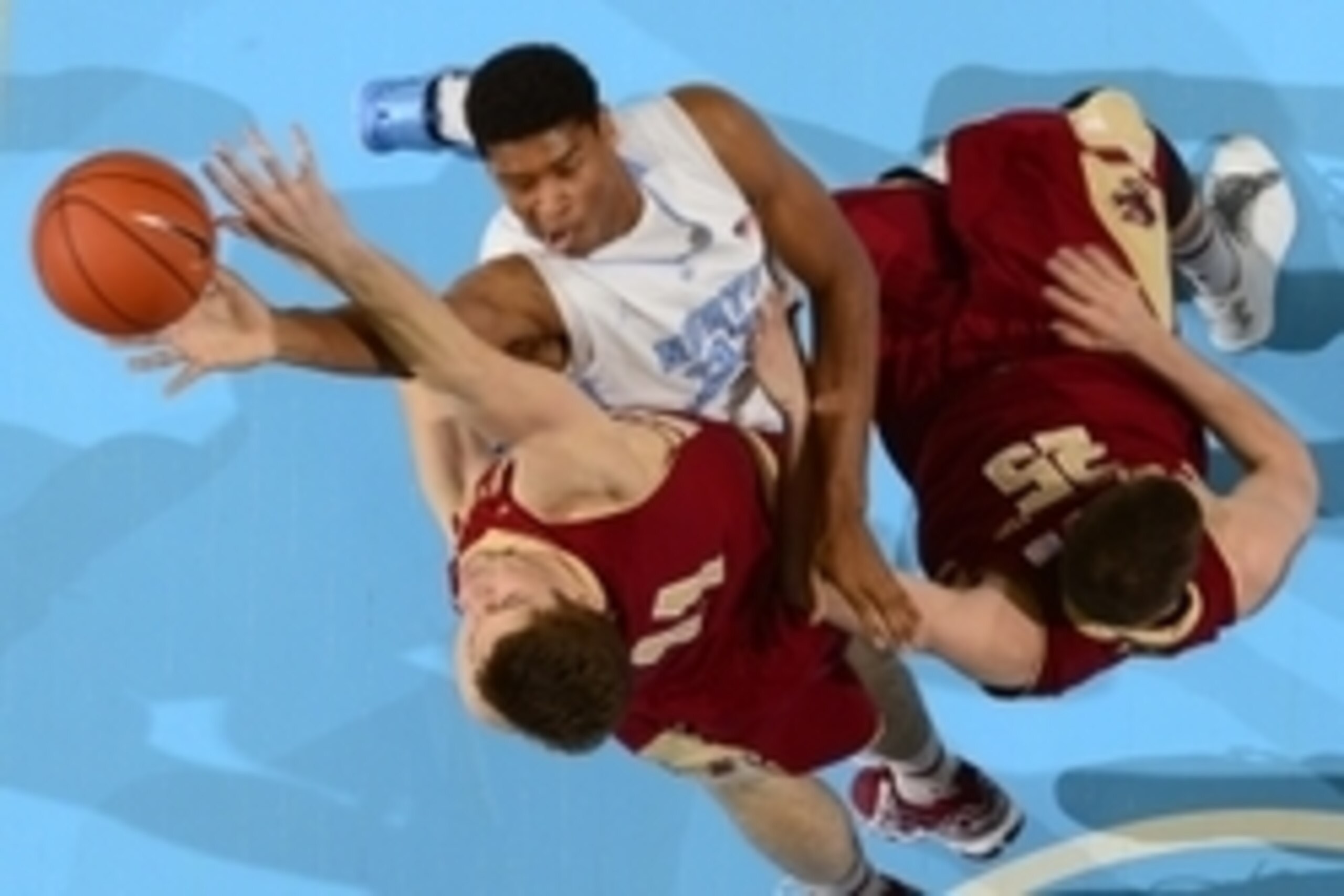 Jan 18, 2014; Chapel Hill, NC, USA;  North Carolina Tar Heels forward Isaiah Hicks (22) shoots as Boston College Eagles forward Will Magarity (11) and guard Joe Rahon (25) defend in the first half. The Tar Heels defeated the Eagles 82-71 at Dean E. Smith 