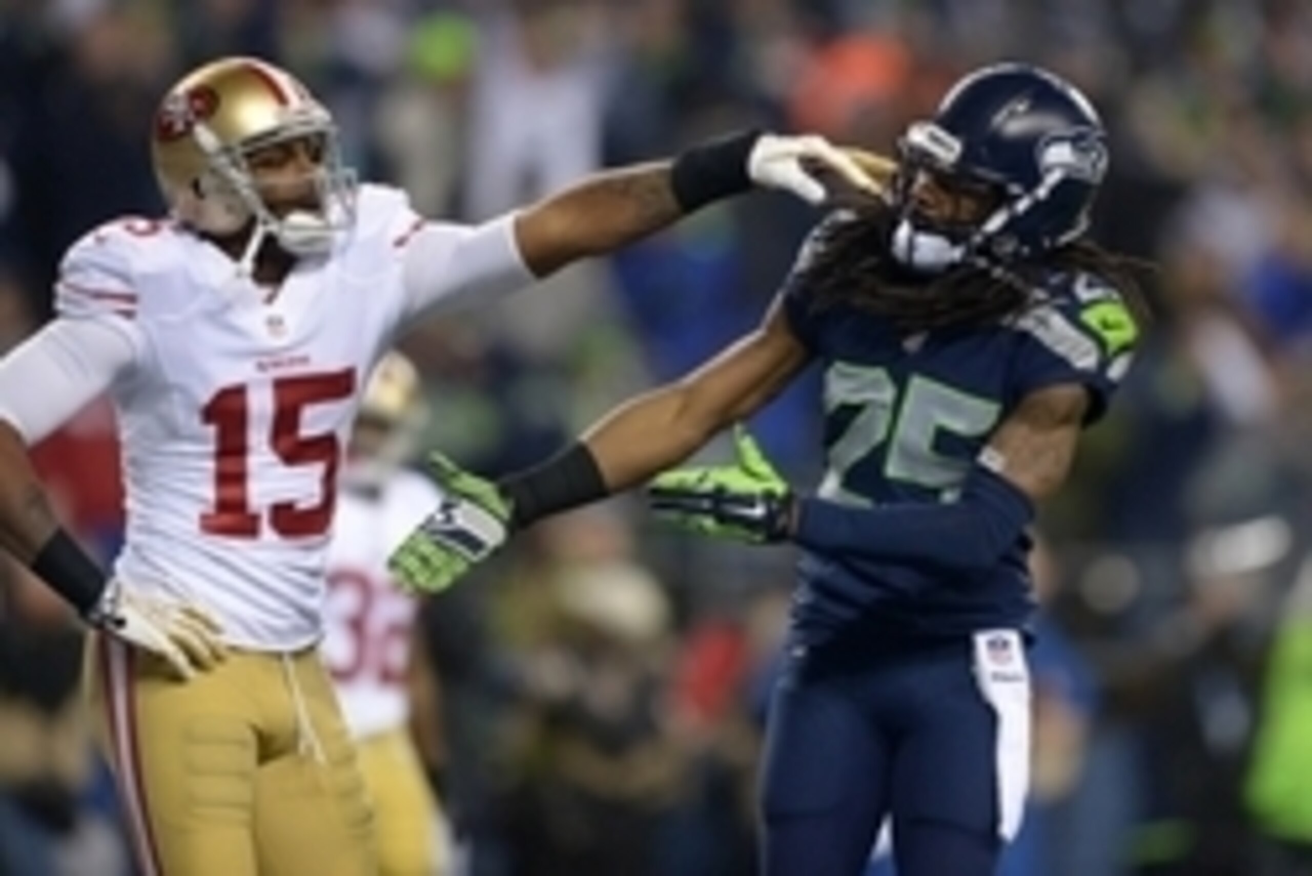 Jan 19, 2014; Seattle, WA, USA; Seattle Seahawks cornerback Richard Sherman (25) gets shoved in the face by San Francisco 49ers wide receiver Michael Crabtree (15) while trying to shake hands after an interception by Seahawks outside linebacker Malcolm Sm