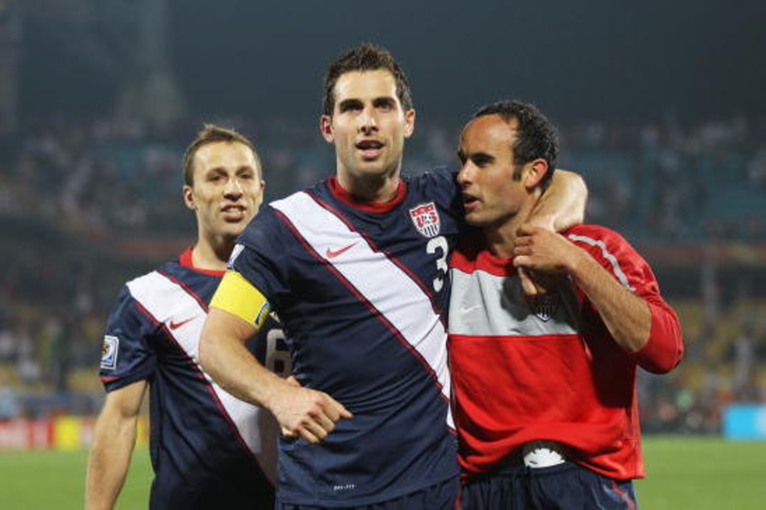 RUSTENBURG, SOUTH AFRICA - JUNE 12: Carlos Bocanegra of the United States (C) celebrates with Steve Cherundolo (L) and Landon Donovan (R) at the final whistle during the 2010 FIFA World Cup South Africa Group C match between England and USA at the Royal B