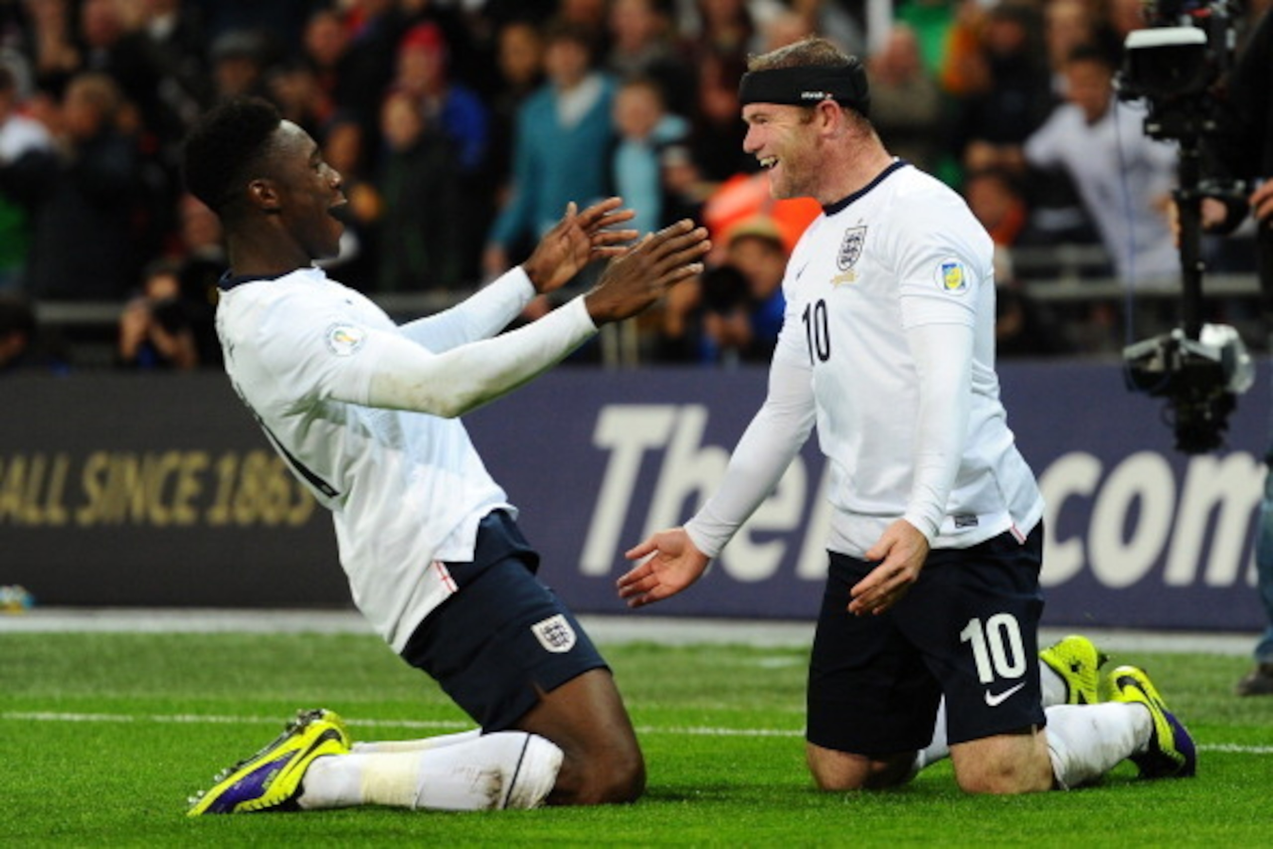 LONDON, ENGLAND - OCTOBER 11:  Wayne Rooney of England celebrates scoring the first goal with Danny Welbeck of England  during the FIFA 2014 World Cup Qualifying Group H match between England and Montenegro at Wembley Stadium on October 11, 2013 in London