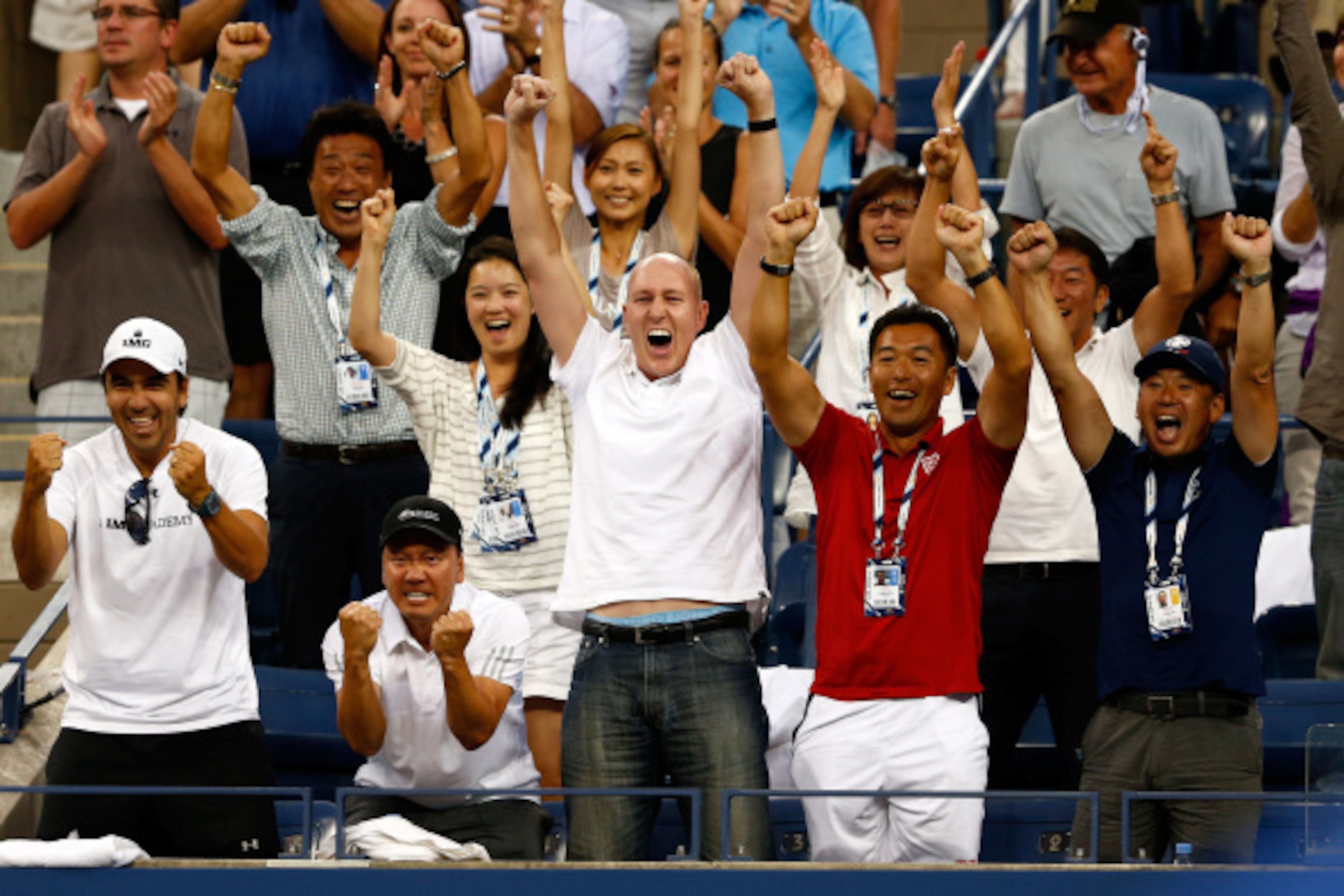 NEW YORK, NY - SEPTEMBER 03:  (L-R) Dante Bottini, Michael Chang, Olivier Van Lindonk, and Koichi Nakao celebrate after Kei Nishikori of Japan defeated Stan Wawrinka of Switzerland in their men's singles quarterfinal match on Day Ten of the 2014 US Open a