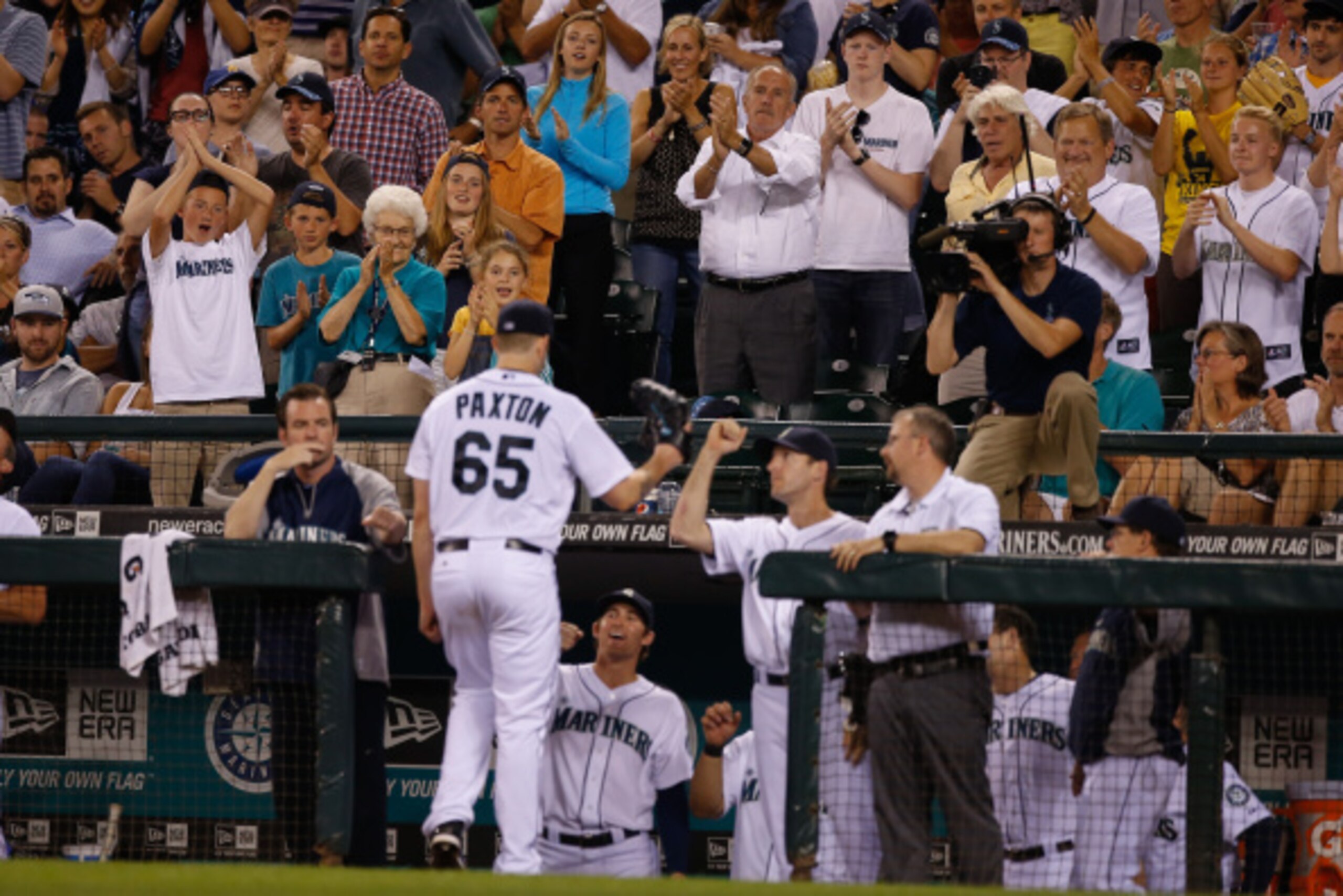 SEATTLE, WA - AUGUST 26:  Starting pitcher James Paxton #65 of the Seattle Mariners gets a hand from the crowd after being removed from the game in the seventh inning against the Texas Rangers at Safeco Field on August 26, 2014 in Seattle, Washington.  (P
