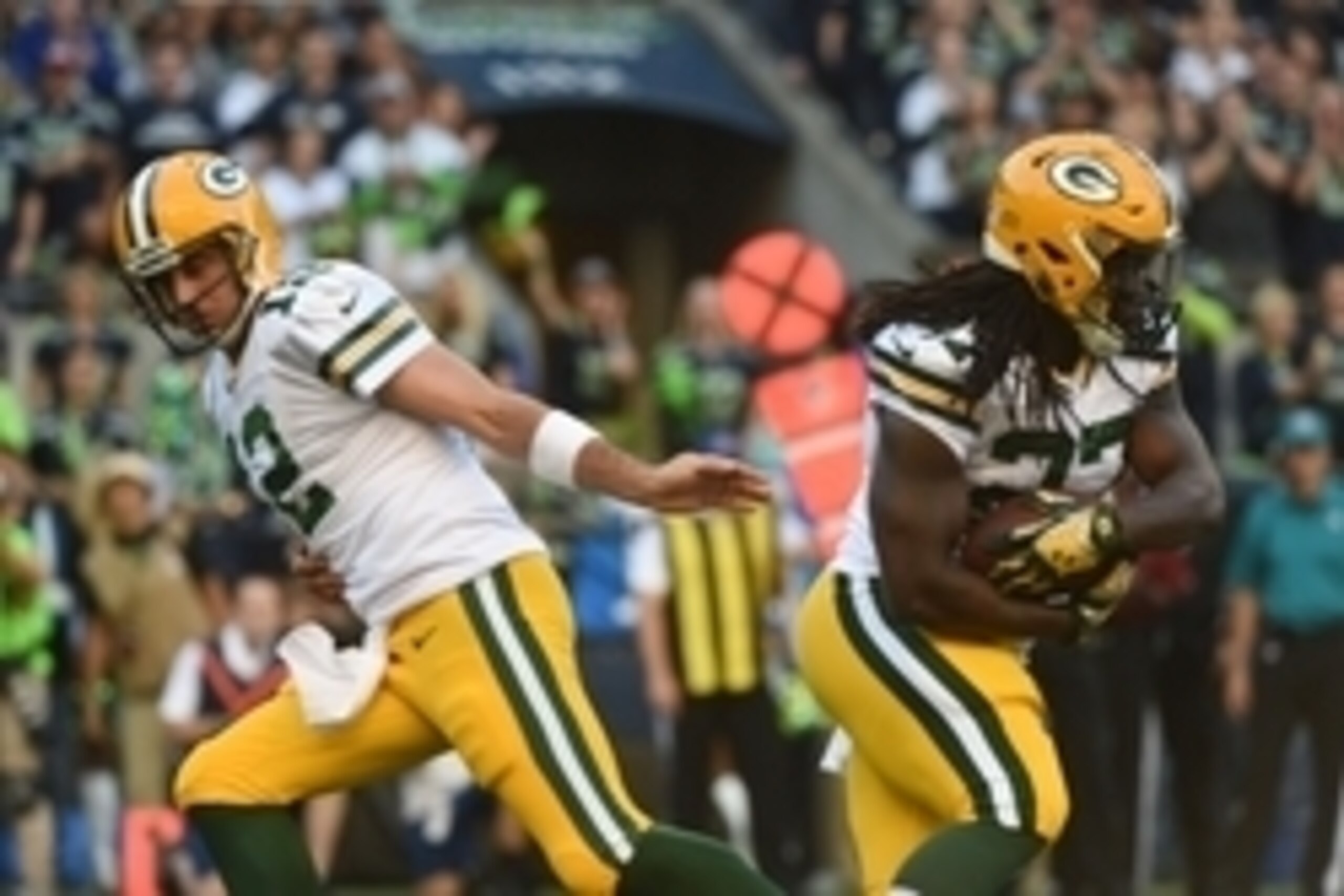 September 4, 2014; Seattle, WA, USA; Green Bay Packers running back Eddie Lacy (27, right) receives the hand off from quarterback Aaron Rodgers (12) against the Seattle Seahawks during the first quarter at CenturyLink Field. Mandatory Credit: Kyle Terada-
