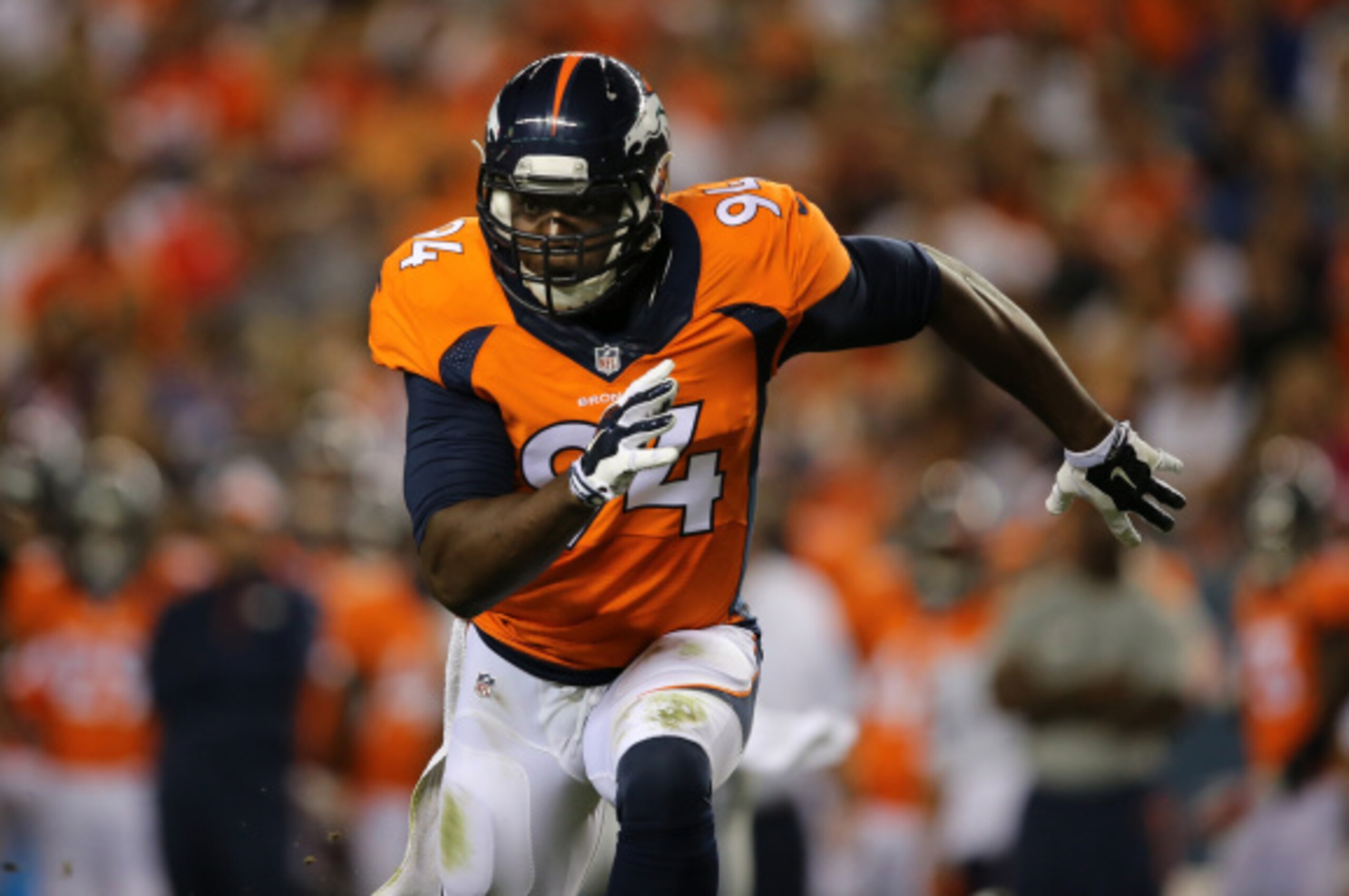 DENVER, CO - AUGUST 07:  Defensive end DeMarcus Ware #94 of the Denver Broncos rushes against the Seattle Seahawks during preseason action at Sports Authority Field at Mile High on August 7, 2014 in Denver, Colorado. The Broncos defeated the Seahawks 21-1
