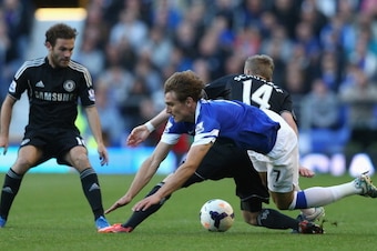 LIVERPOOL, ENGLAND - SEPTEMBER 14:  Andre Schurrle of Chelsea tangles with Nikica Jelavic of Everton during the Barclays Premier League match between Everton and Chelsea at Goodison Park on September 14, 2013 in Liverpool, England.  (Photo by Clive Brunsk