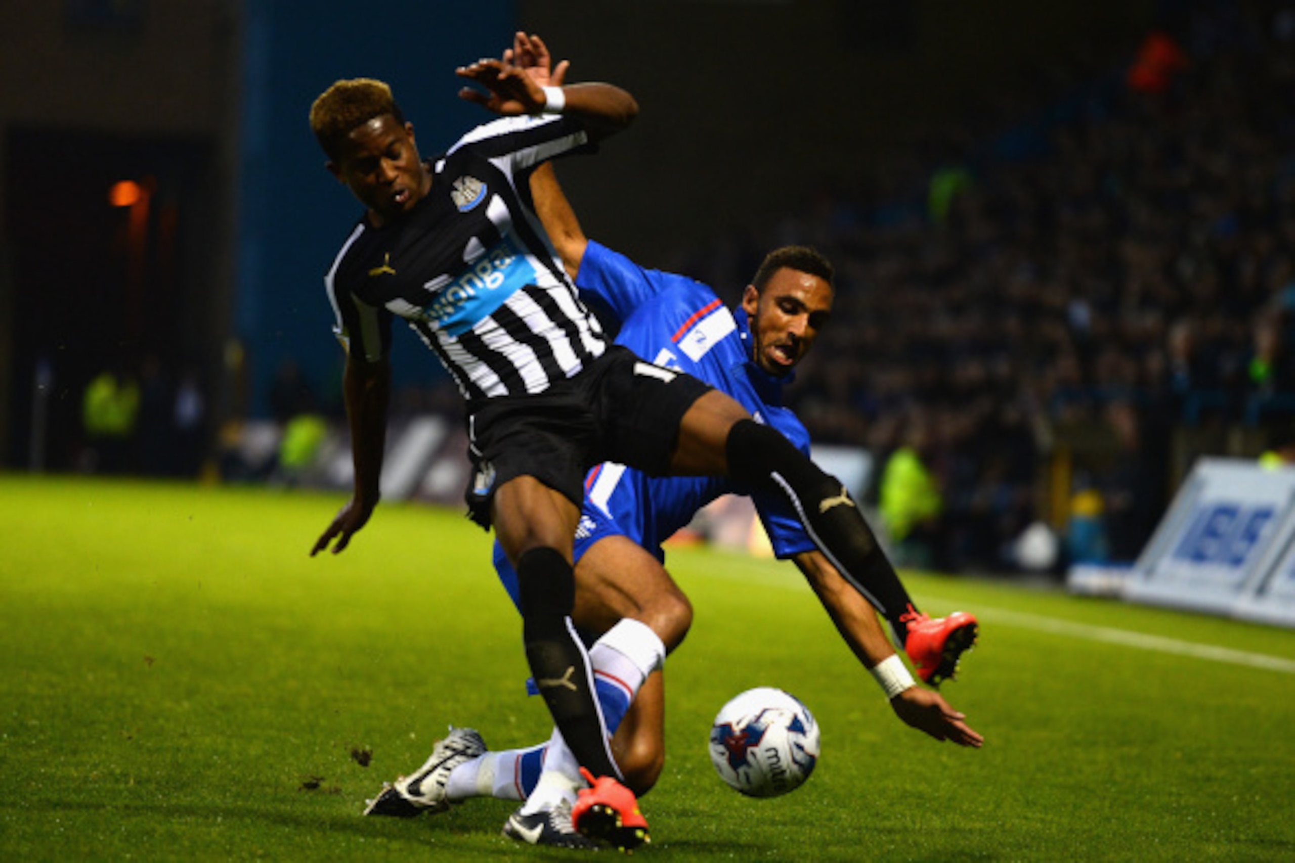 GILLINGHAM, UNITED KINGDOM - AUGUST 26:  Leon Legge of Gillingham tackles Rolando Aarons of Newcastle United during the Capital One Cup second round match between Gillingham and Newcastle United at Priestfield Stadium on August 26, 2014 in Gillingham, Uni