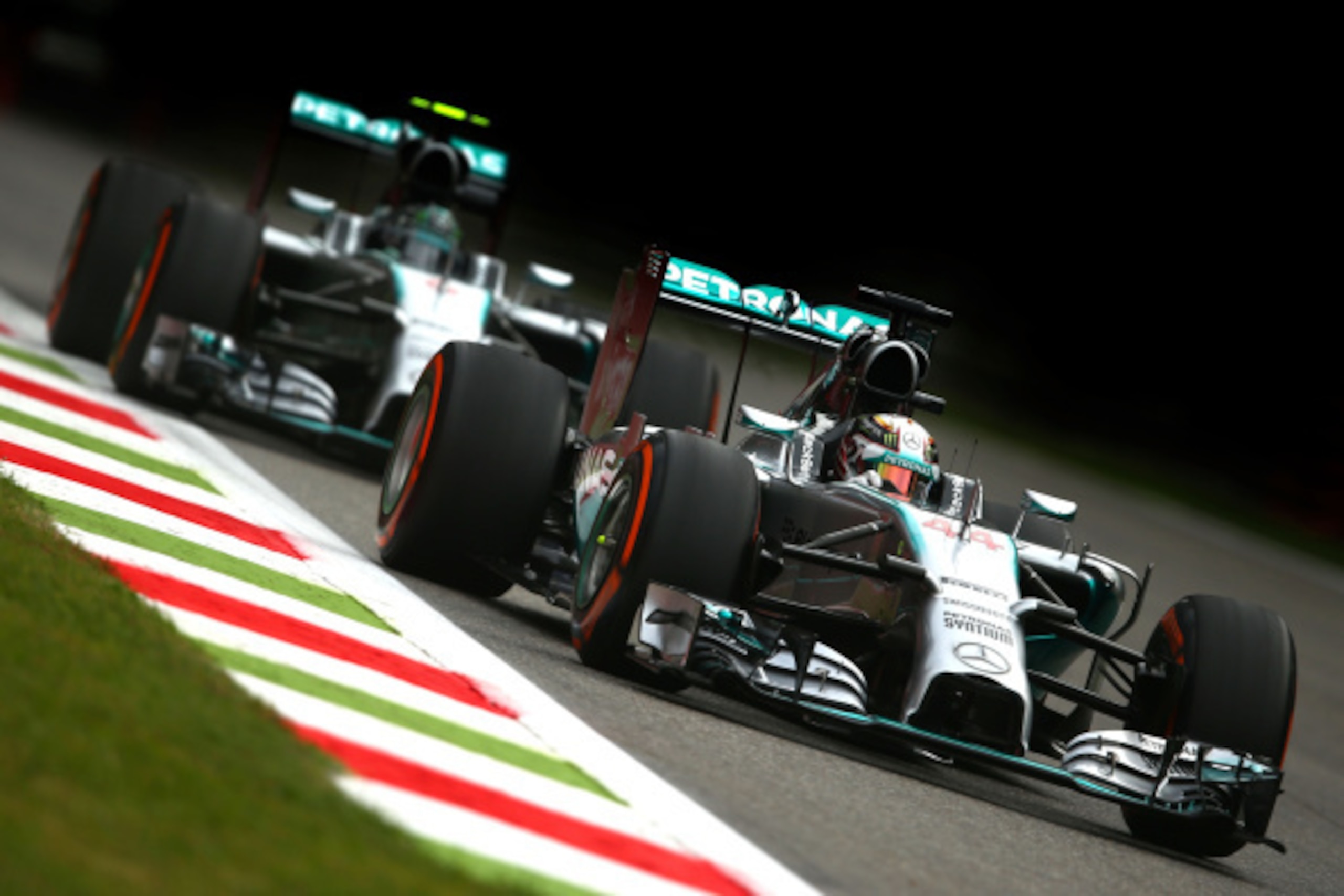 MONZA, ITALY - SEPTEMBER 05:  (R-L) Lewis Hamilton of Great Britain and Mercedes GP and Nico Rosberg of Germany and Mercedes GP drive during Practice ahead of the F1 Grand Prix of Italy at Autodromo di Monza on September 5, 2014 in Monza, Italy.  (Photo b