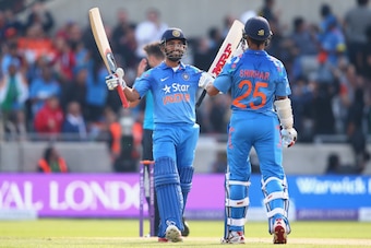 BIRMINGHAM, ENGLAND - SEPTEMBER 02:  Shikhar Dhawan (R) is congratulated by Ajinkya Rahane (L) of India after hitting a six off the bowling of James Anderson to reach his half century during the fourth Royal London One-Day Series match between England and