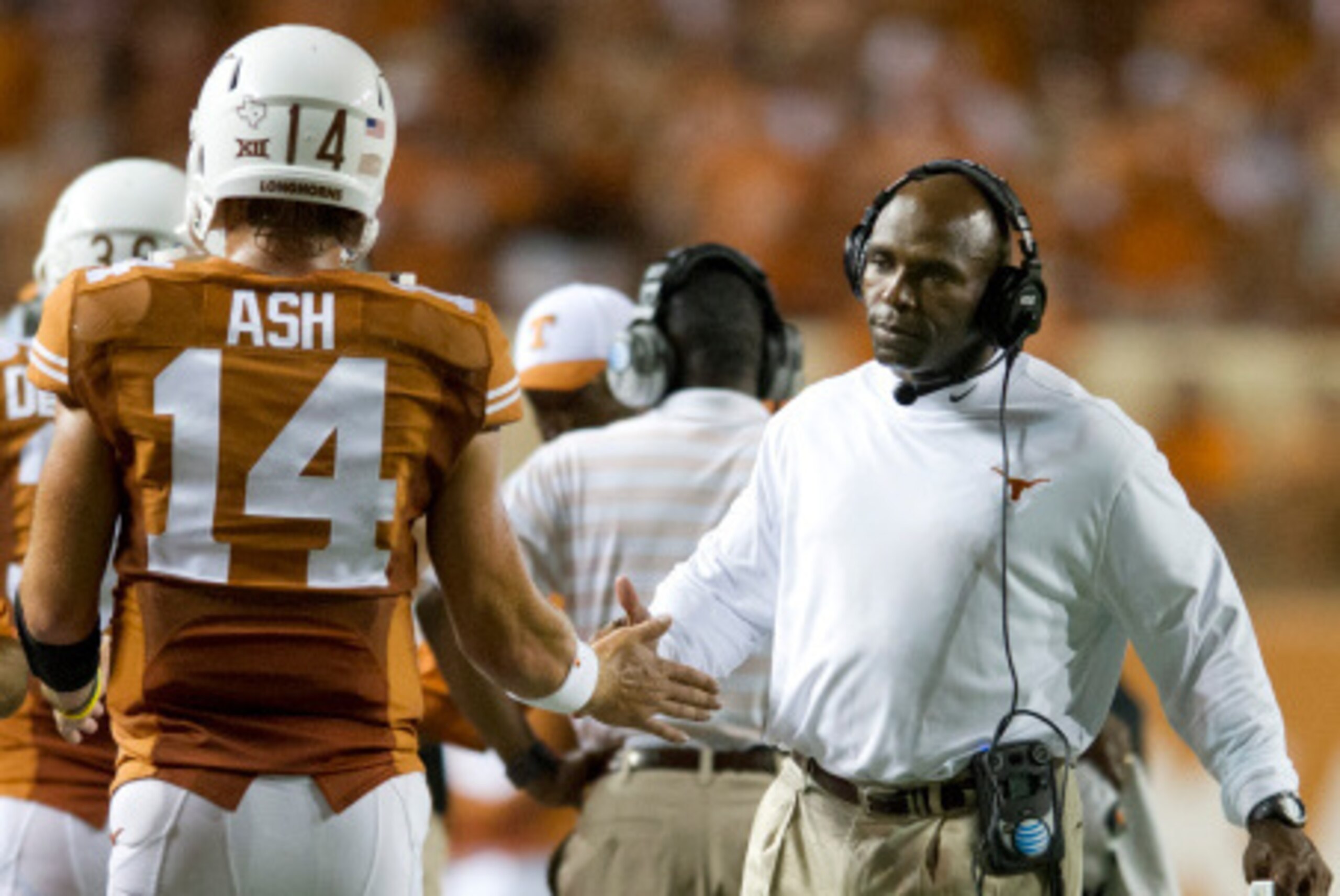 AUSTIN, TX - AUGUST 30:  Texas Longhorns head coach Charlie Strong congratulates quarterback David Ash #14 after throwing a touchdown against the North Texas Mean Green during the third quarter on August 30, 2014 at Darrell K Royal-Texas Memorial Stadium 