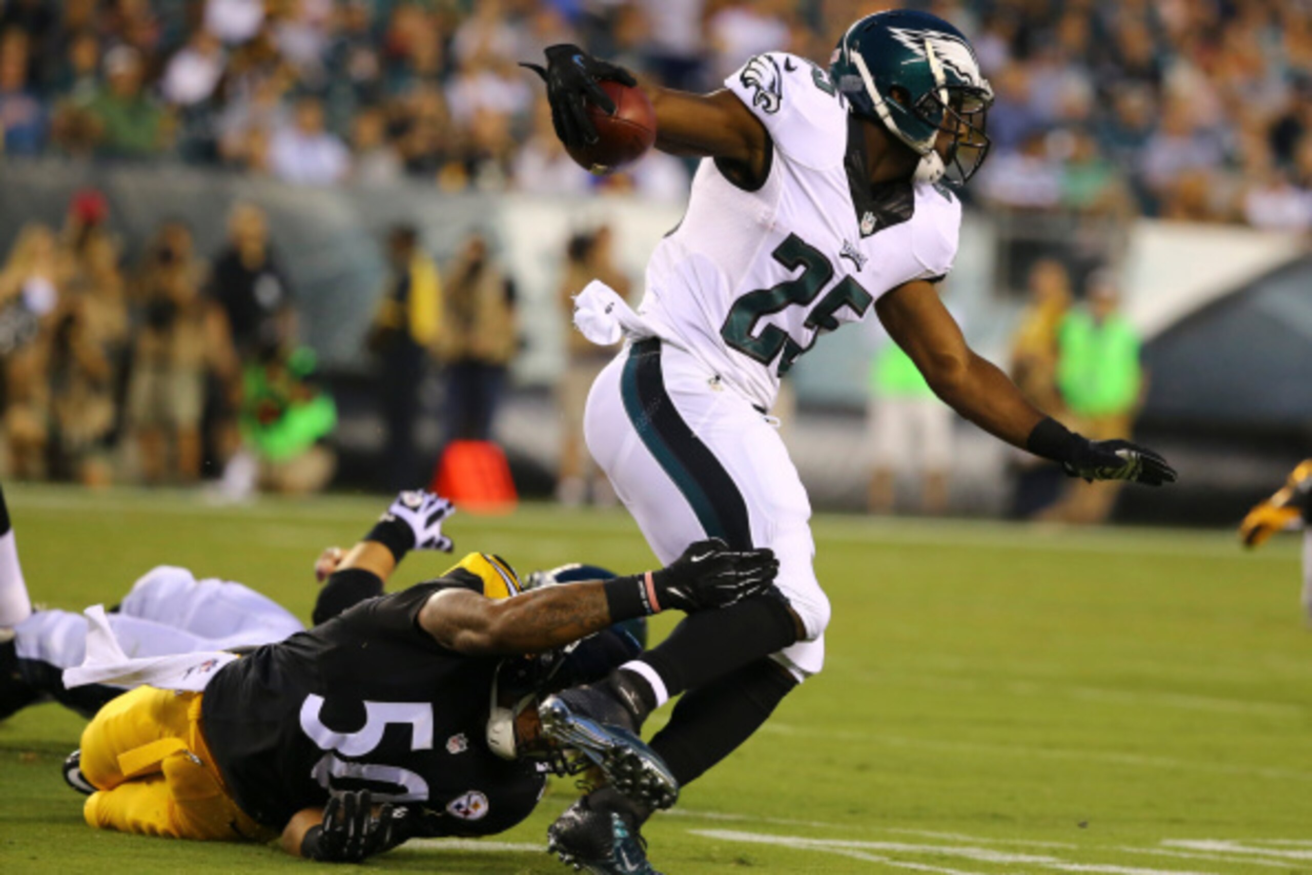 PHILADELPHIA, PA - AUGUST 21: Running back LeSean McCoy #25 of the Philadelphia Eagles runs the ball and linebacker Ryan Shazier #50 of the Pittsburgh Steelers attempts to tackle him on the play on August 21, 2014 at Lincoln Financial Field in Philadelphi
