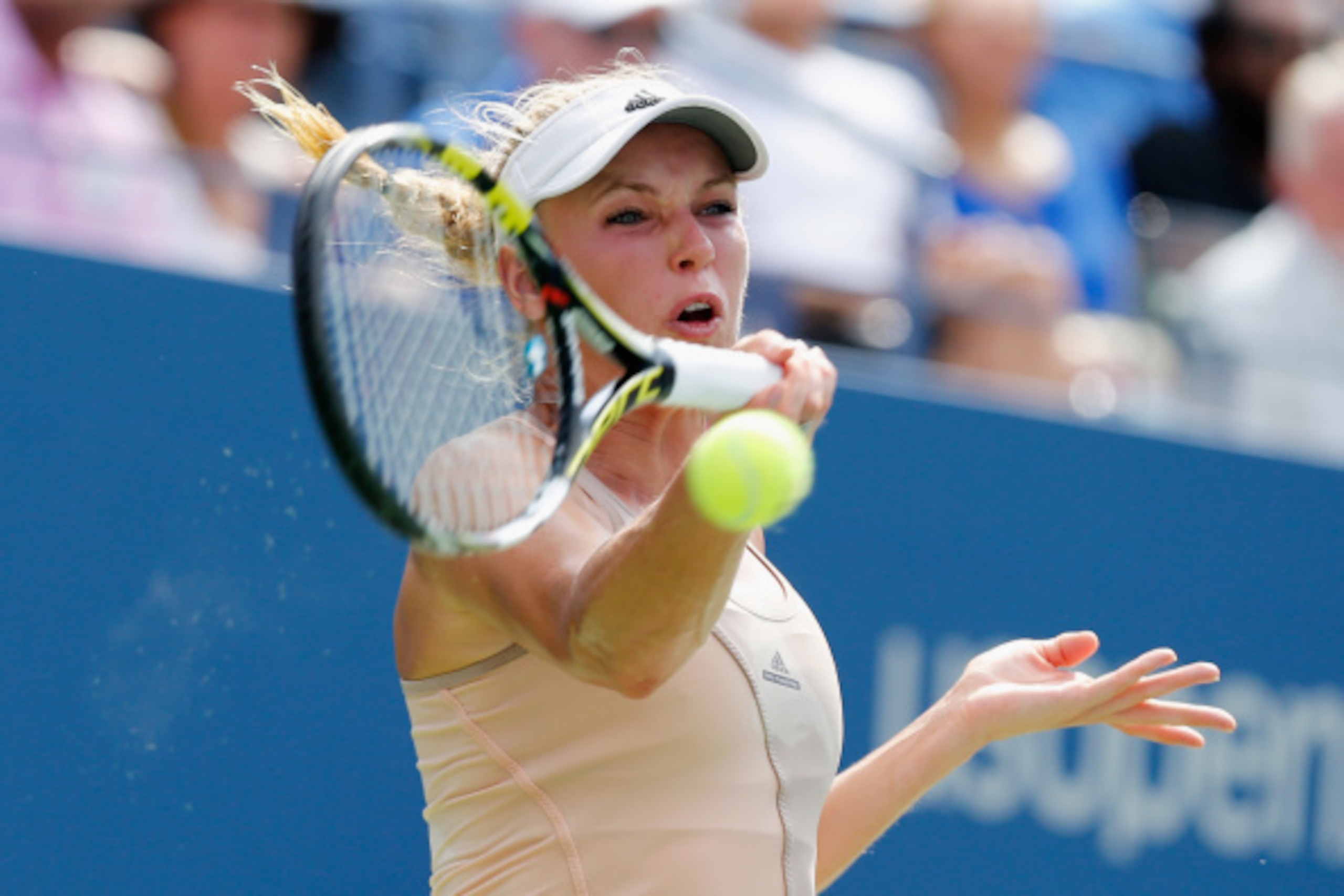 NEW YORK, NY - SEPTEMBER 05:  Caroline Wozniacki of Denmark returns a shot against Shuai Peng of China during their women's singles semifinal match on Day Twelve of the 2014 US Open at the USTA Billie Jean King National Tennis Center on September 5, 2014 