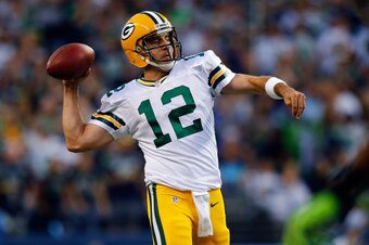 SEATTLE - SEPTEMBER 04:  Quarterback Aaron Rodgers #12 of the Green Bay Packers passes the ball during the third quarter of the game against the Seattle Seahawks at Century Link Field on September 4, 2014 in Seattle, Washington.  (Photo by Jonathan Ferrey