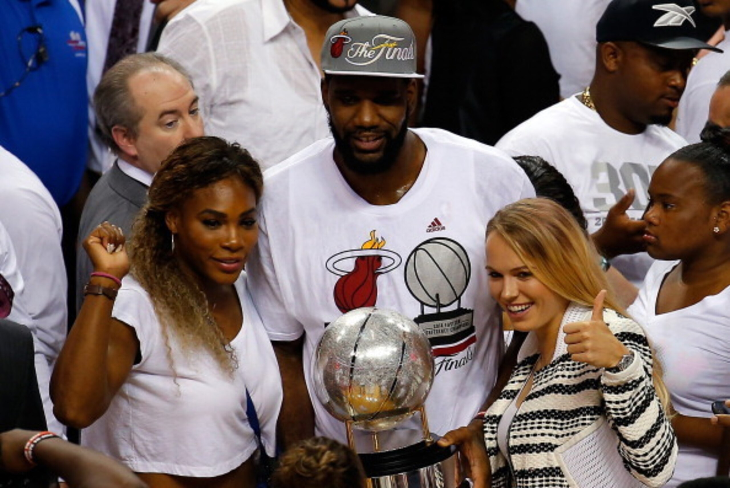 MIAMI, FL - MAY 30:  Tennis players Serena Williams and Caroline Wozniacki celebrate with Greg Oden #20 of the Miami Heat after defeating the Indiana Pacers in Game Six of the Eastern Conference Finals of the 2014 NBA Playoffs at American Airlines Arena o