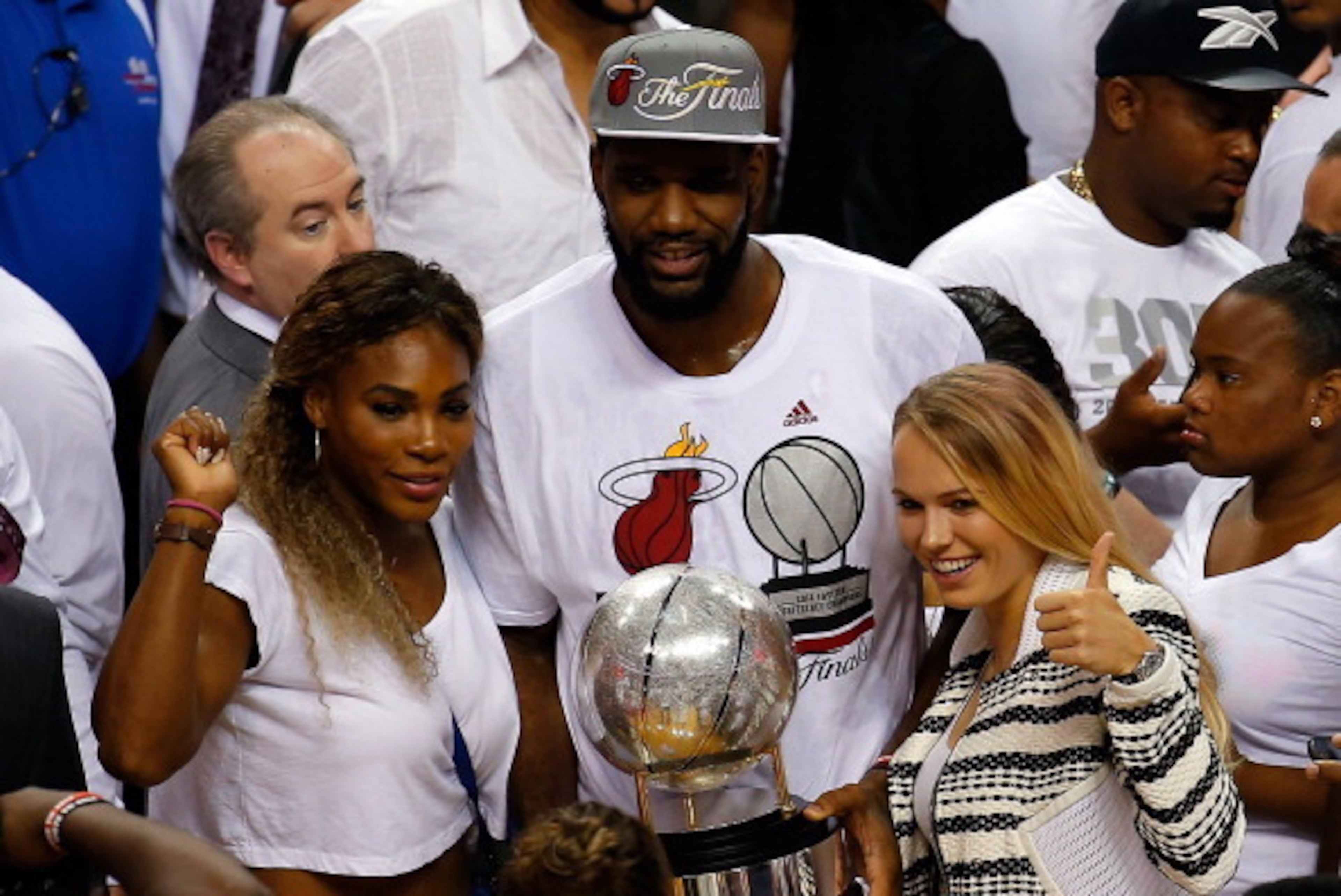 MIAMI, FL - MAY 30:  Tennis players Serena Williams and Caroline Wozniacki celebrate with Greg Oden #20 of the Miami Heat after defeating the Indiana Pacers in Game Six of the Eastern Conference Finals of the 2014 NBA Playoffs at American Airlines Arena o