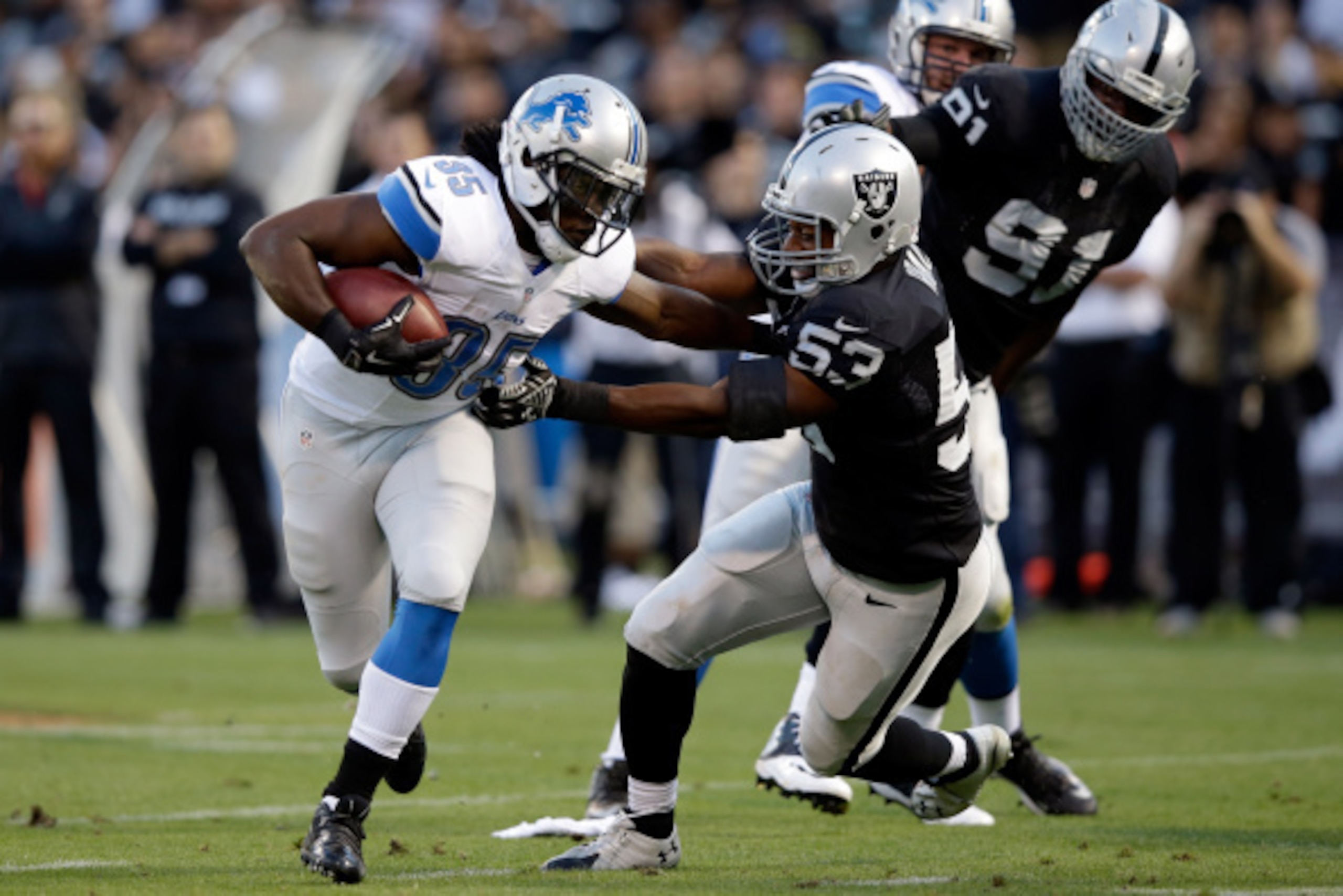 OAKLAND, CA - AUGUST 15:  Running back Joique Bell #35 of the Detroit Lions runs against line backer Nick Roach #53 of the Oakland Raiders during their preseason game at O.co Coliseum on August 15, 2014 in Oakland, California.  (Photo by Ezra Shaw/Getty I