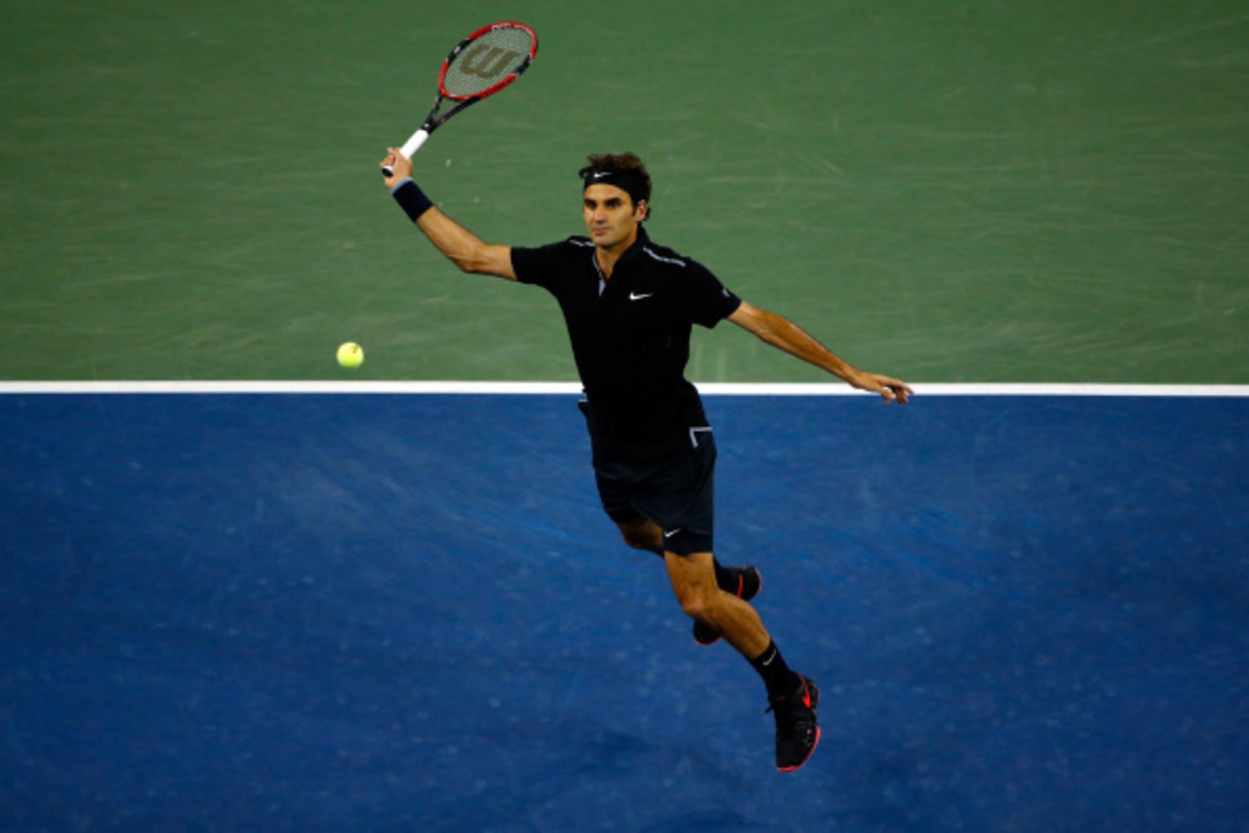 NEW YORK, NY - SEPTEMBER 04:  Roger Federer of Switzerland returns a shot against Gael Monfils of France during their men's singles quarterfinal match on Day Eleven of the 2014 US Open at the USTA Billie Jean King National Tennis Center on September 3, 20