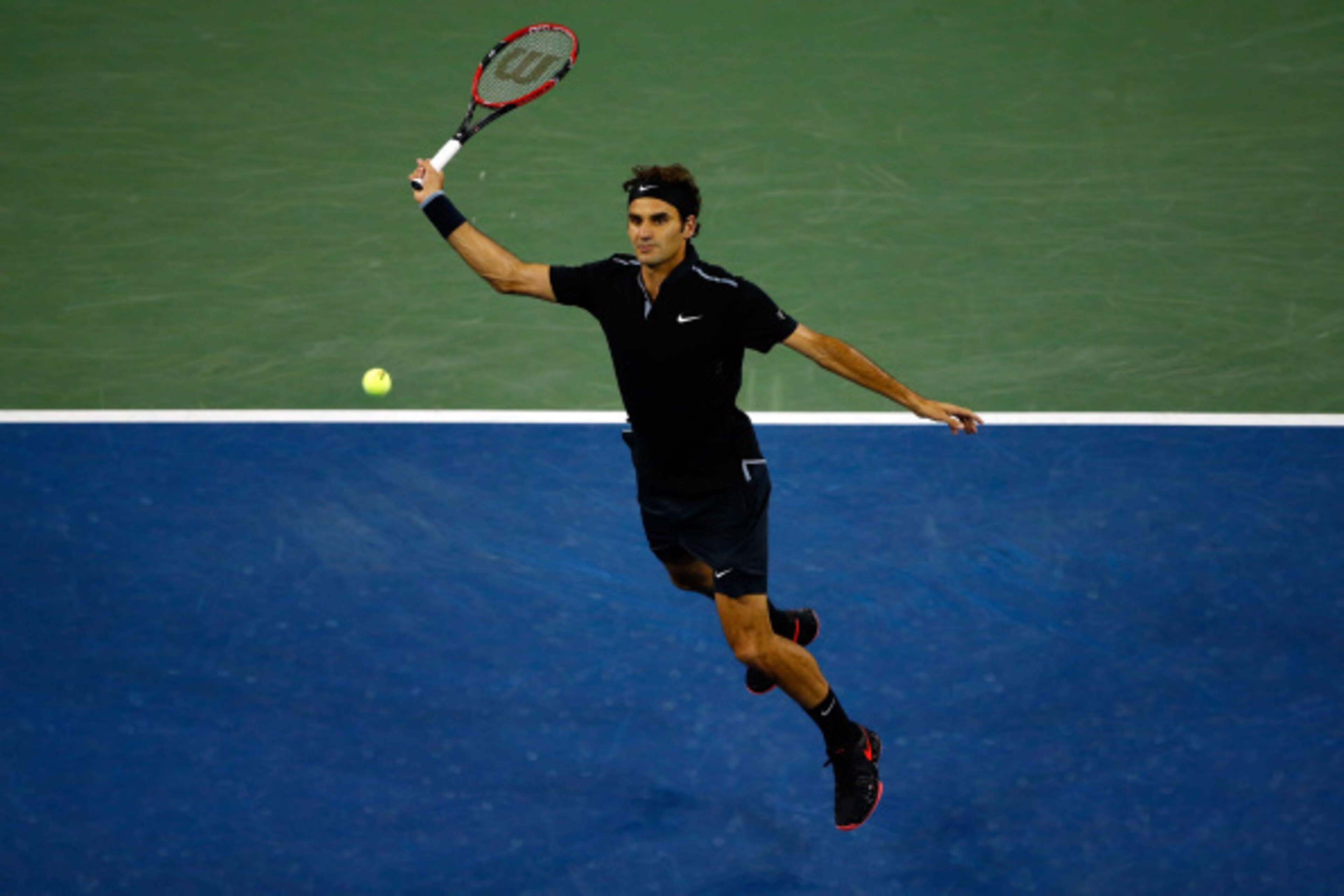 NEW YORK, NY - SEPTEMBER 04:  Roger Federer of Switzerland returns a shot against Gael Monfils of France during their men's singles quarterfinal match on Day Eleven of the 2014 US Open at the USTA Billie Jean King National Tennis Center on September 3, 20