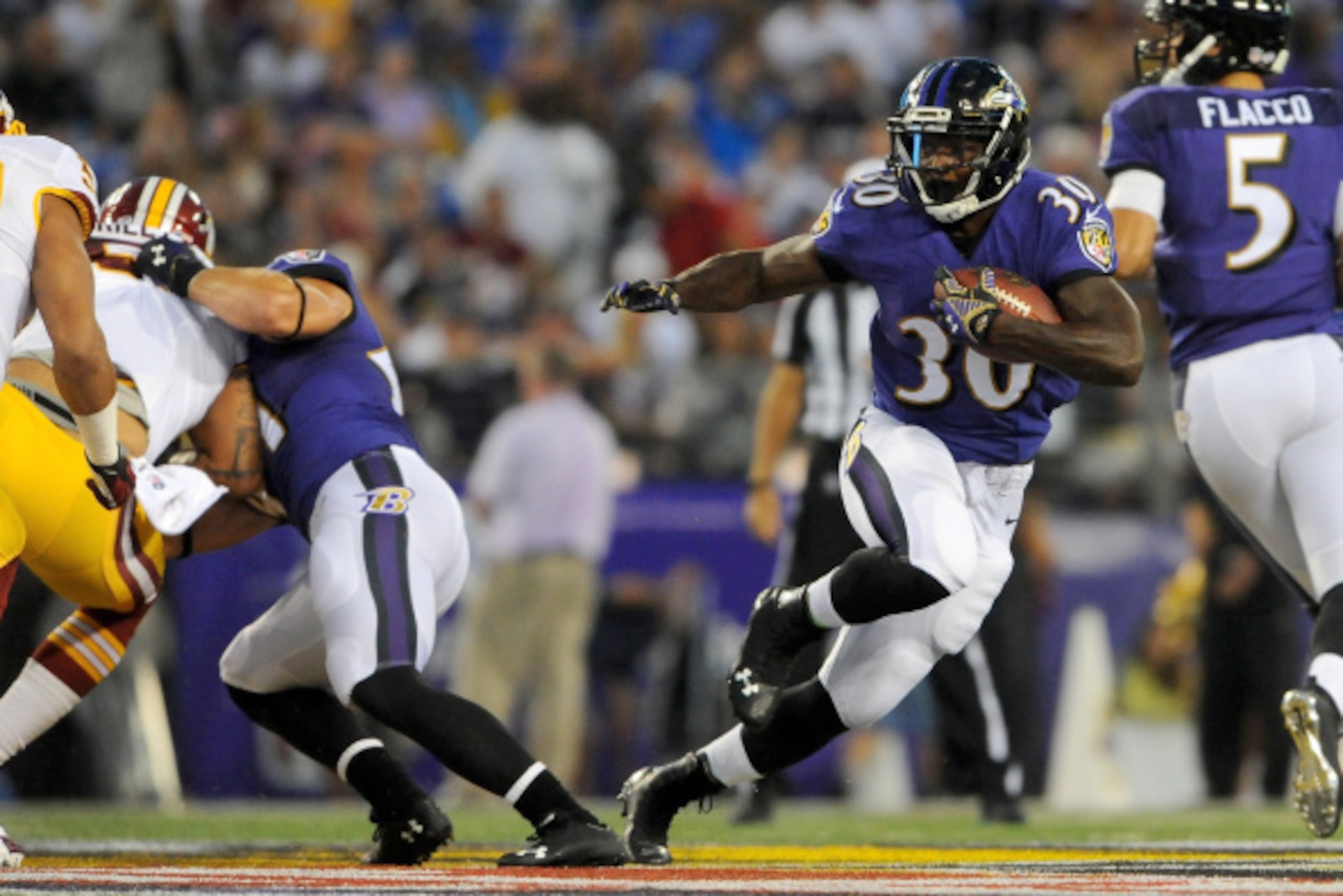 BALTIMORE, MD - AUGUST 23:  Running back Bernard Pierce #30 of the Baltimore Ravens rushes during a preseason game against the Washington Redskins at M&T Bank Stadium on August 23, 2014 in Baltimore, Maryland.  (Photo by Larry French/Getty Images)