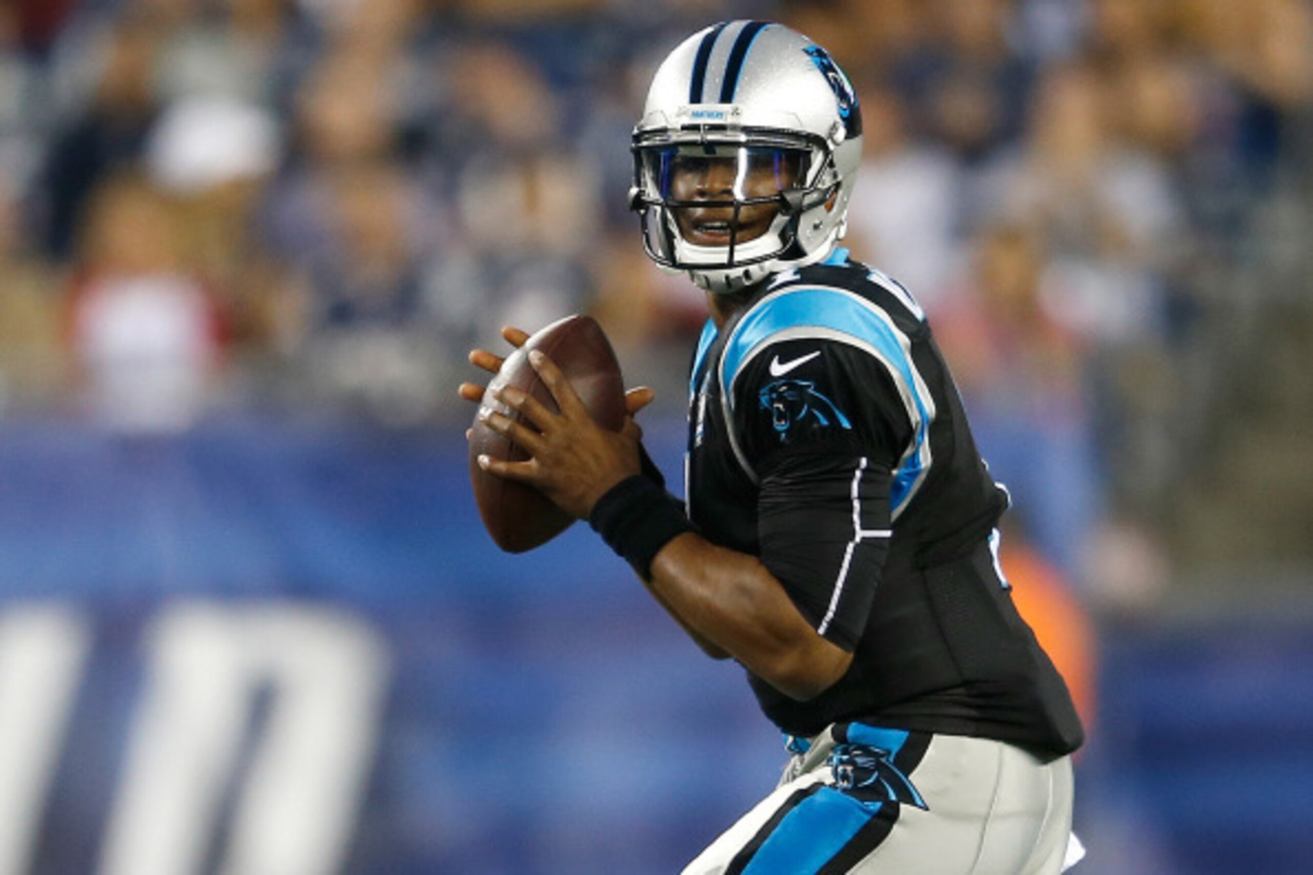 FOXBORO, MA - AUGUST 22: Cam Newton #1 of the Carolina Panthers looks for an open man against the New England Patriots in the first quarter at Gillette Stadium on August 22, 2014 in Foxboro, Massachusetts. (Photo by Jim Rogash/Getty Images)