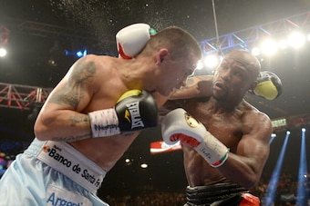 LAS VEGAS, NV - MAY 03:  (L-R) Marcos Maidana and  Floyd Mayweather Jr. exchange blows during their WBC/WBA welterweight unification fight at the MGM Grand Garden Arena on May 3, 2014 in Las Vegas, Nevada. Mayweather took Maidana's title with a majority-d