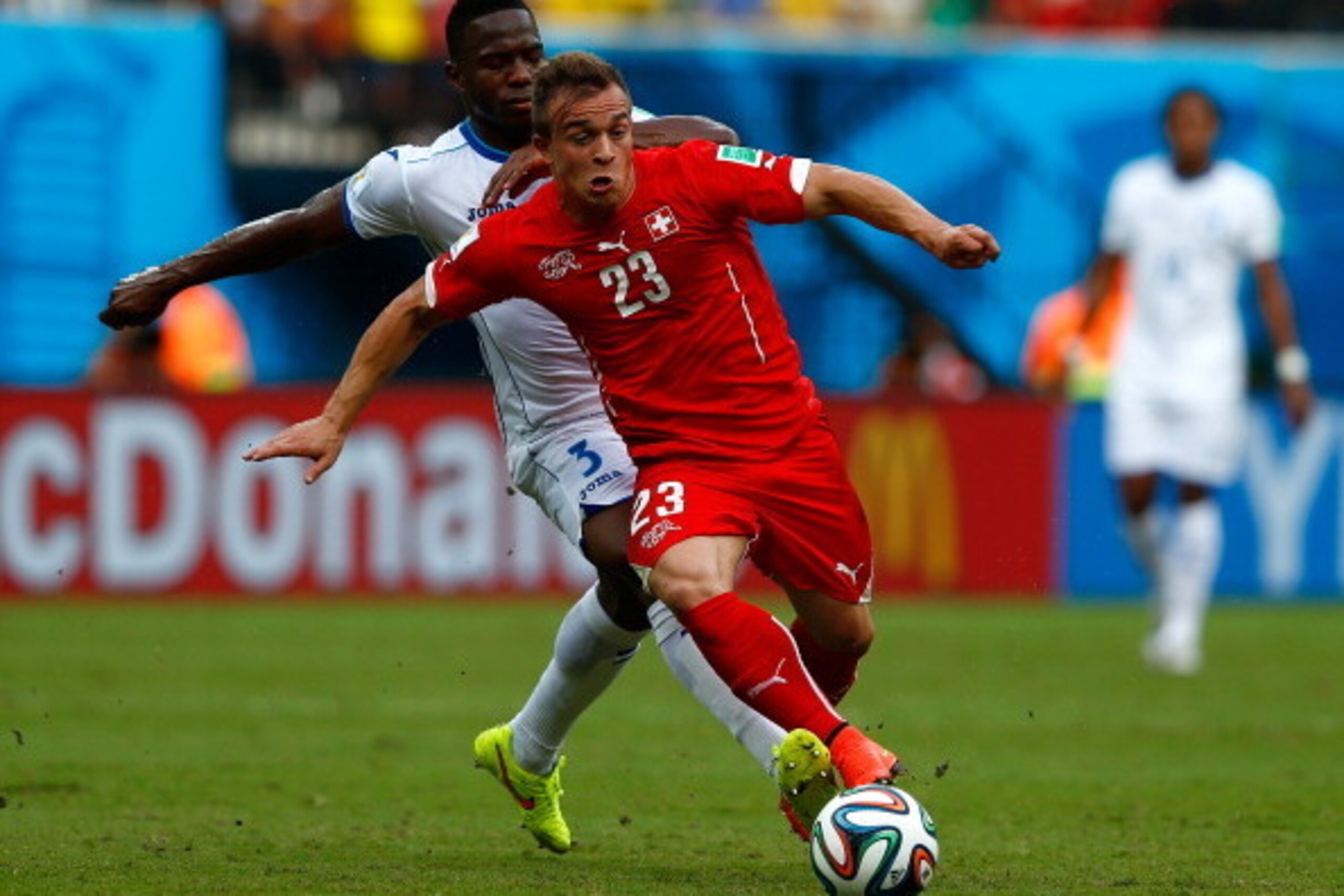MANAUS, BRAZIL - JUNE 25:  Xherdan Shaqiri of Switzerland controls the ball as Maynor Figueroa of Honduras gives chase during the 2014 FIFA World Cup Brazil Group E match between Honduras and Switzerland at Arena Amazonia on June 25, 2014 in Manaus, Brazi