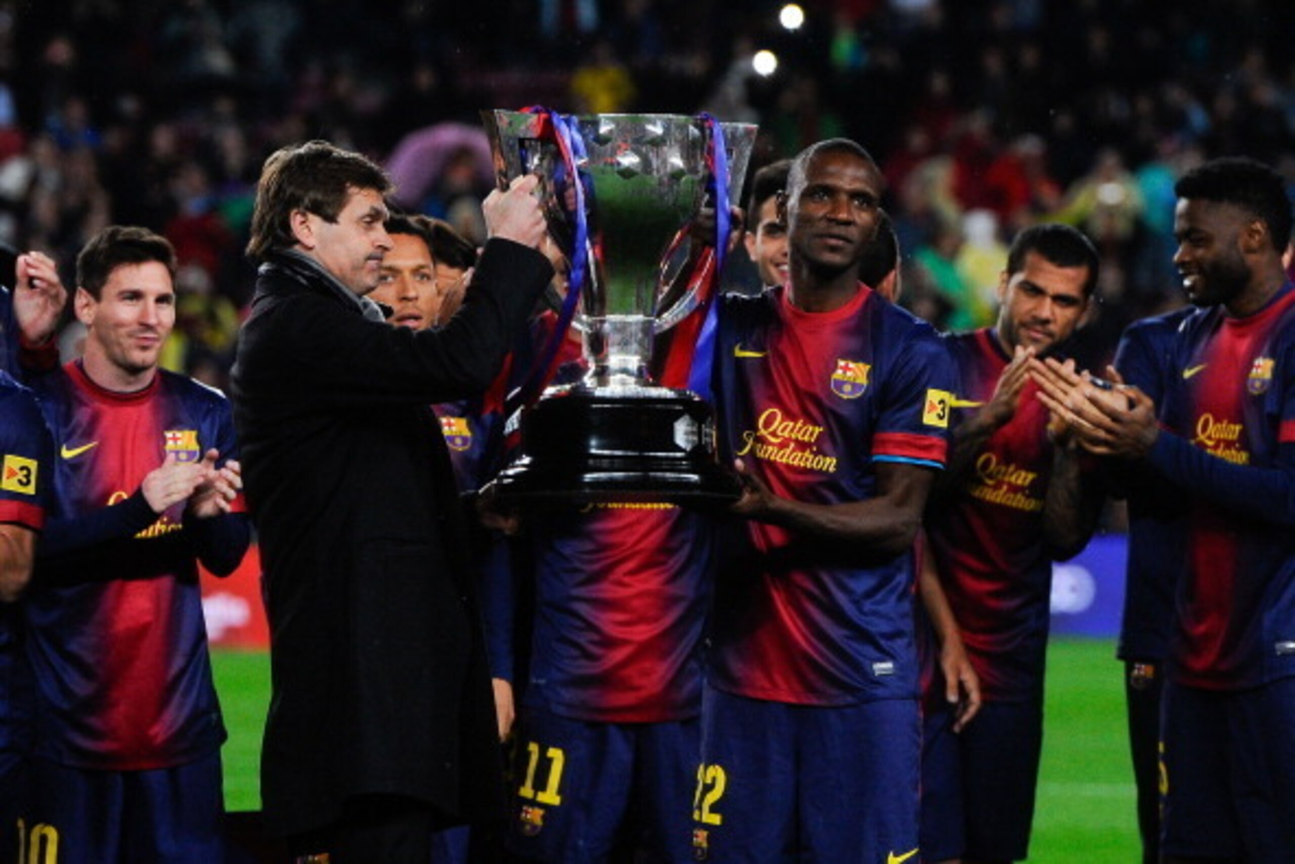 BARCELONA, SPAIN - MAY 19: Head coach Tito Vilanova and Eric Abidal of FC Barcelona holds up the trophy during the celebration after winning the Spanish League after the La Liga match between FC Barcelona and Real Valladolid CF at Camp Nou on May 19, 201 BARCELONA, SPAIN - MAY 19: Head coach Tito Vilanova and Eric Abidal of FC Barcelona holds up the trophy during the celebration after winning the Spanish League after the La Liga match between FC Barcelona and Real Valladolid CF at Camp Nou on May 19, 201