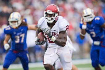 TULSA, OK - SEPTEMBER 6:  Keith Ford #21 of the Oklahoma Sooners runs the ball for a touchdown during a game against the Tulsa Golden Hurricanes at H.A. Chapman Stadium on September 6, 2014 in Tulsa, Oklahoma.  (Photo by Wesley Hitt/Getty Images)