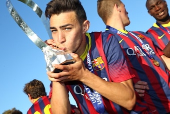 NYON, SWITZERLAND - APRIL 14: Munir El Haddadi of FC Barcelona kisses the Lennart Johansson trophy in celebration after victoy during the UEFA Youth League Final match between Benfica Lisbon and FC Barcelona at Colovray Stadion on April 14, 2014 in Nyon, 