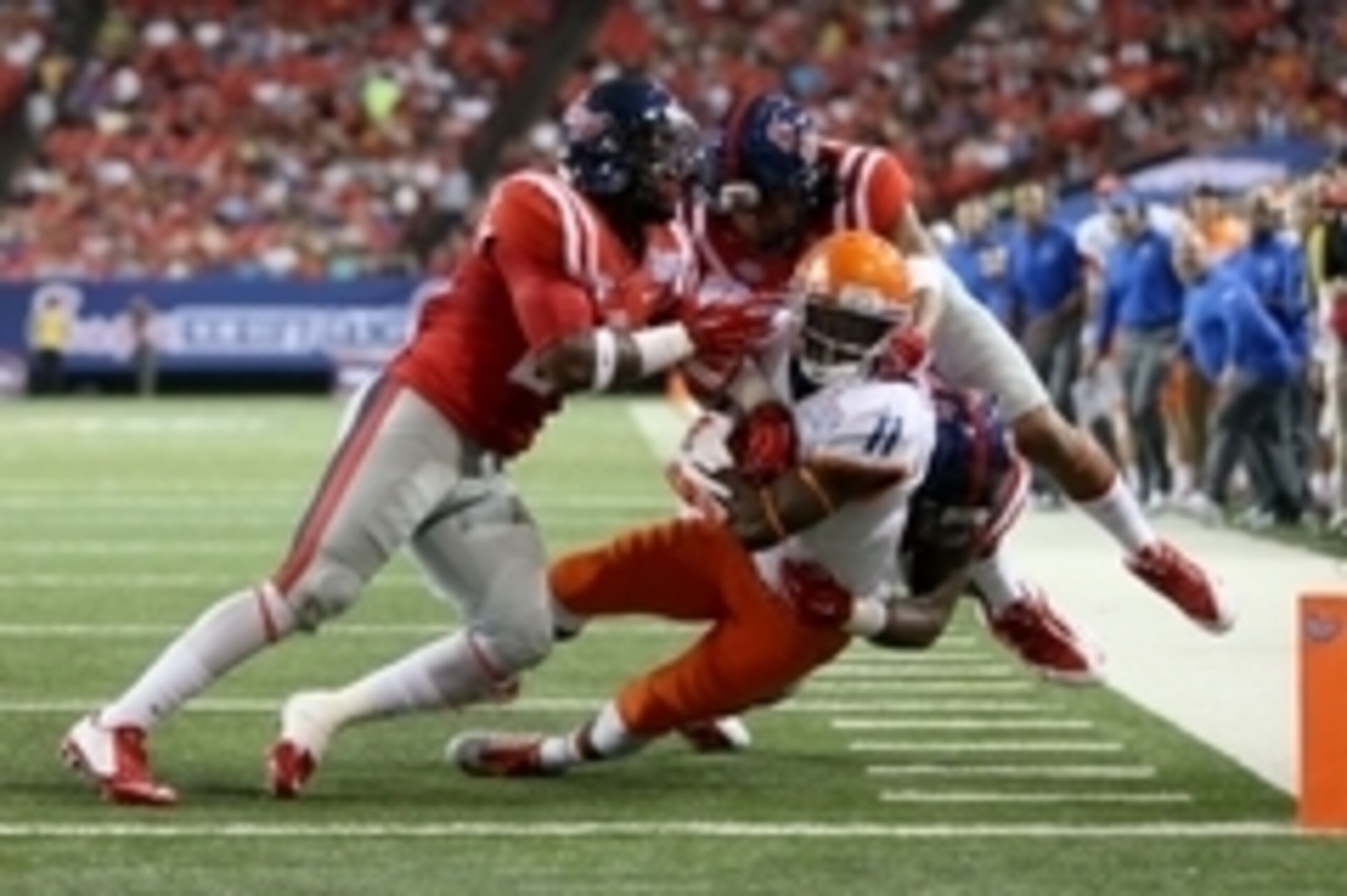 Aug 28, 2014; Atlanta, GA, USA; Boise State Broncos wide receiver Shane Williams-Rhodes (11) is brought down short of the goal line by Mississippi Rebels linebacker Keith Lewis (24), defensive back Cody Prewitt (25) and defensive end C.J. Johnson (10) in 