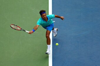 NEW YORK, NY - SEPTEMBER 06:  Roger Federer of Switzerland returns a shot against Marin Cilic of Croatia during their men's singles semifinal match on Day Thirteen of the 2014 US Open at the USTA Billie Jean King National Tennis Center on September 6, 201