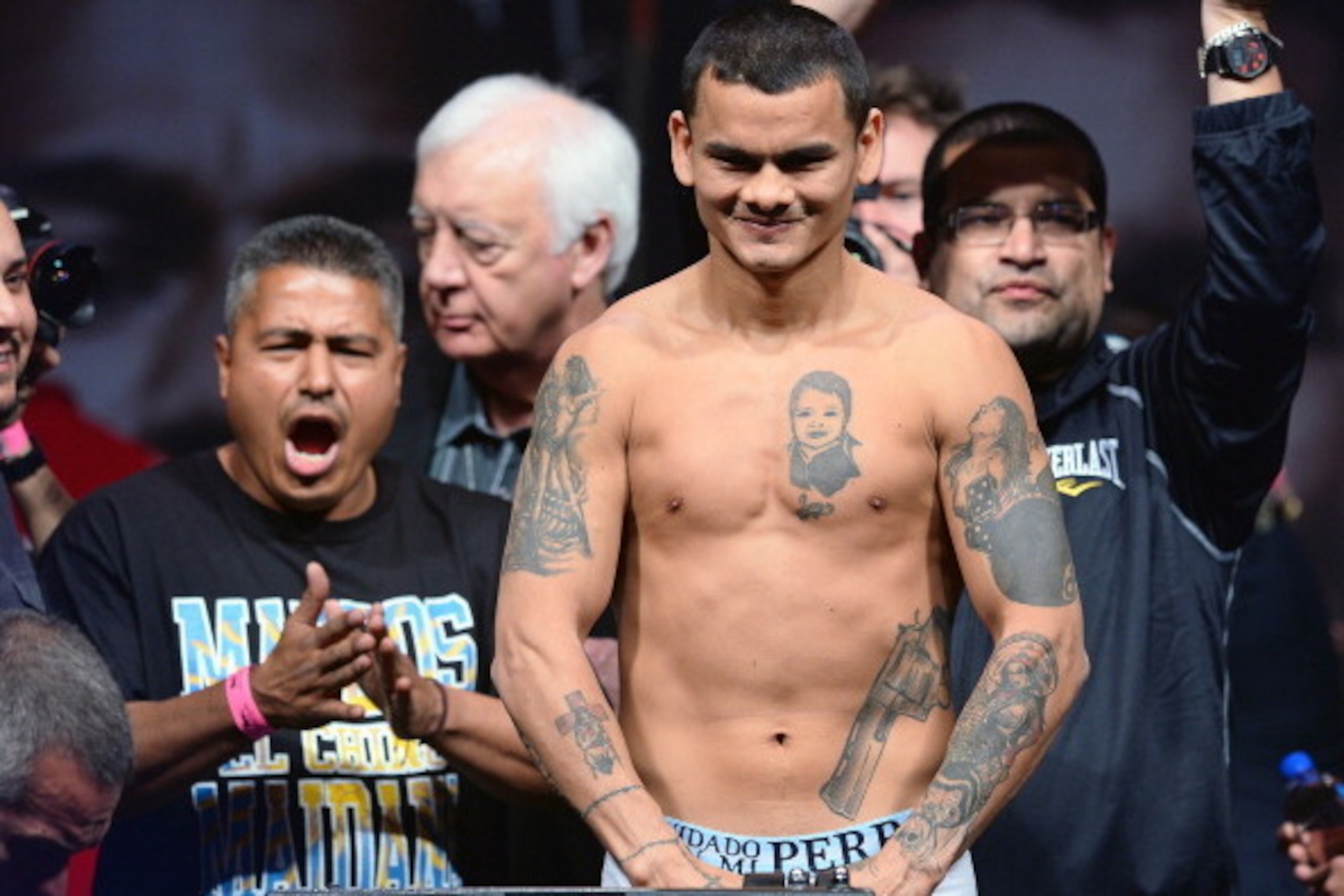 LAS VEGAS, NV - MAY 02:  WBA welterweight champion Marcos Maidana poses on the scale during his official weigh-in as his trainer Robert Garcia (L) looks on at the MGM Grand Garden Arena on May 2, 2014 in Las Vegas, Nevada. Maidana will meet WBC champion F
