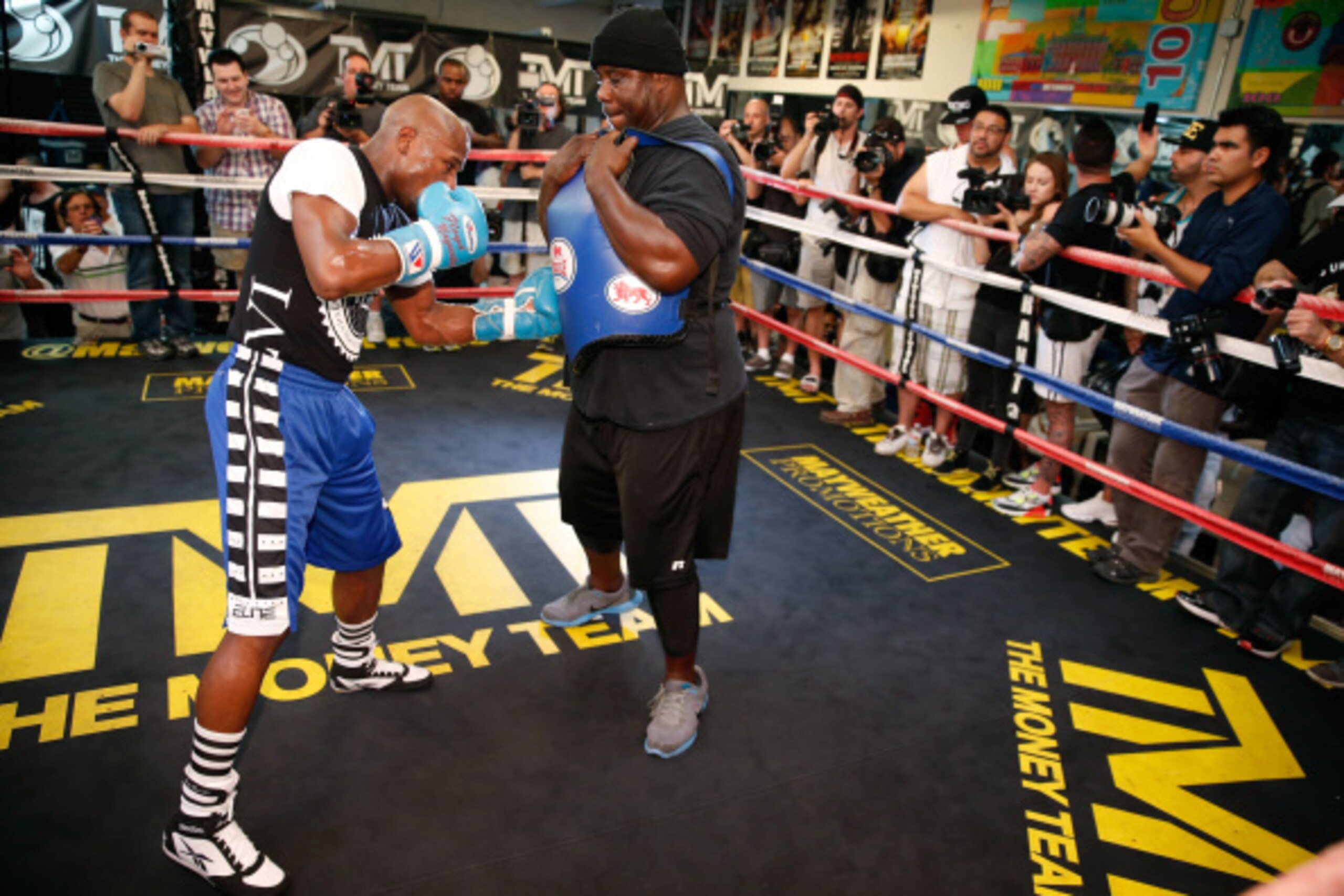 LAS VEGAS, NV - SEPTEMBER 02:  Boxer Floyd Mayweather Jr. (L) works out with co-trainer Nate Jones at the Mayweather Boxing Club on September 2, 2014 in Las Vegas, Nevada. Mayweather Jr. will defend his WBC/WBA welterweight titles against Marcos Maidana o