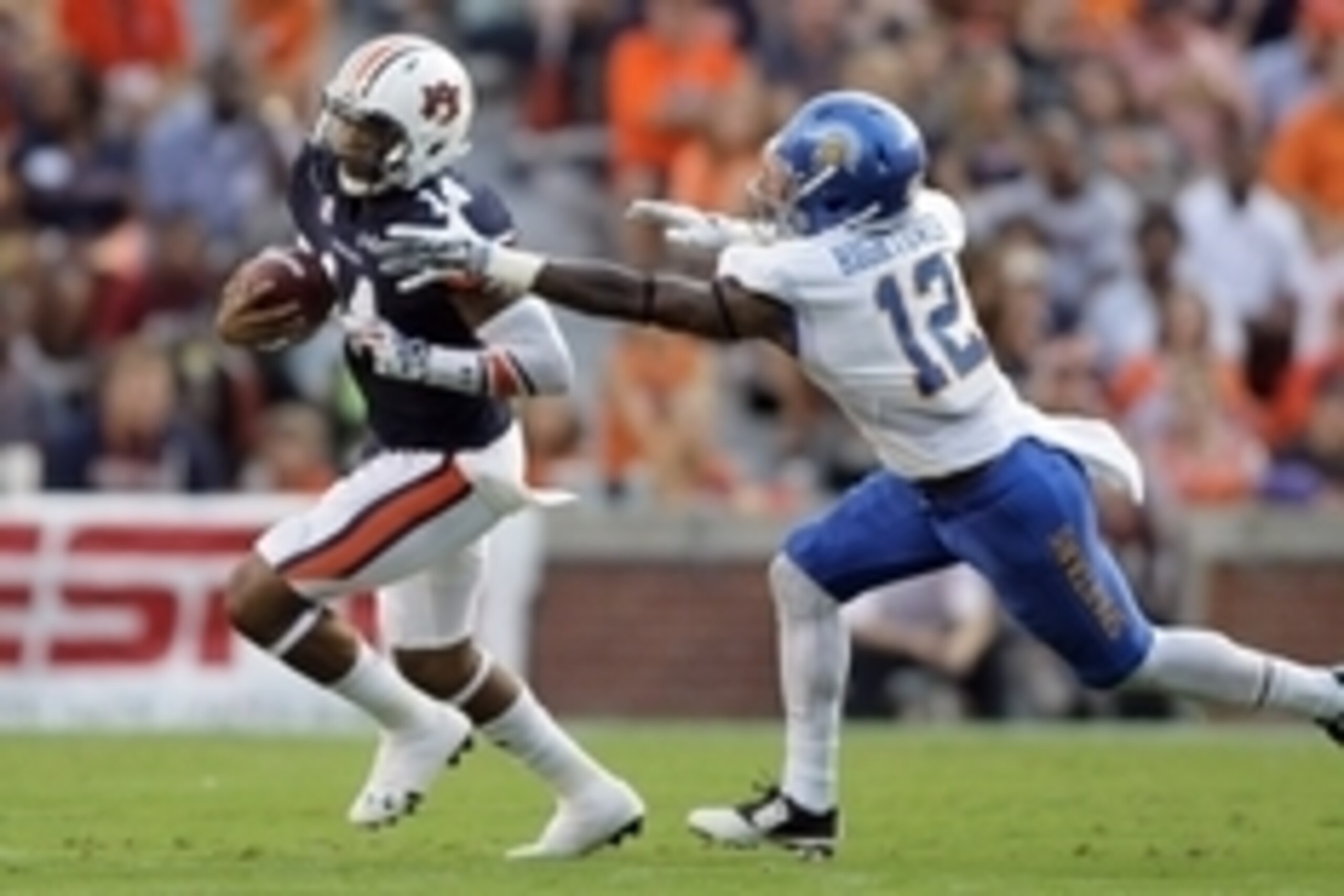 Sep 6, 2014; Auburn, AL, USA;  Auburn Tigers quarterback Nick Marshall (14) tries to avoid San Jose State Spartans safety Forrest Hightower (12) during the first half at Jordan Hare Stadium. Mandatory Credit: John Reed-USA TODAY Sports